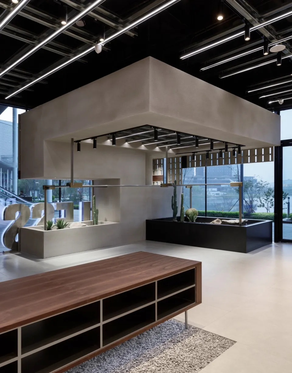 A modern office space featuring a concrete and wooden desk, with a minimalist design.