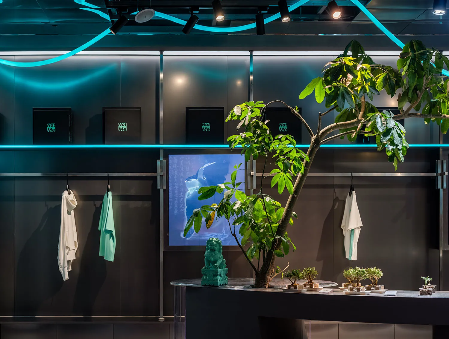 A modern retail shop interior featuring green plants and natural elements.