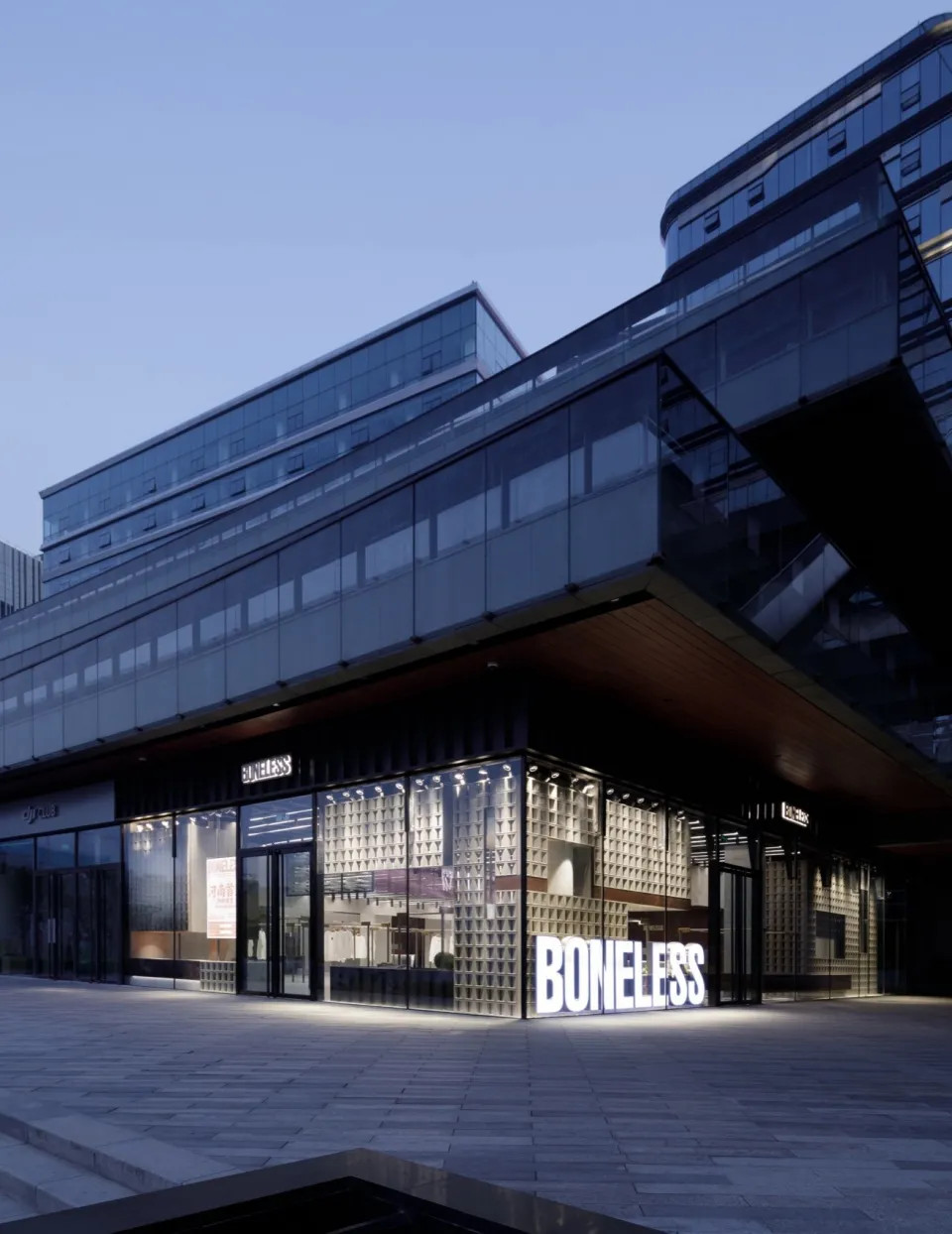 Modern retail storefront with glass and concrete materials.