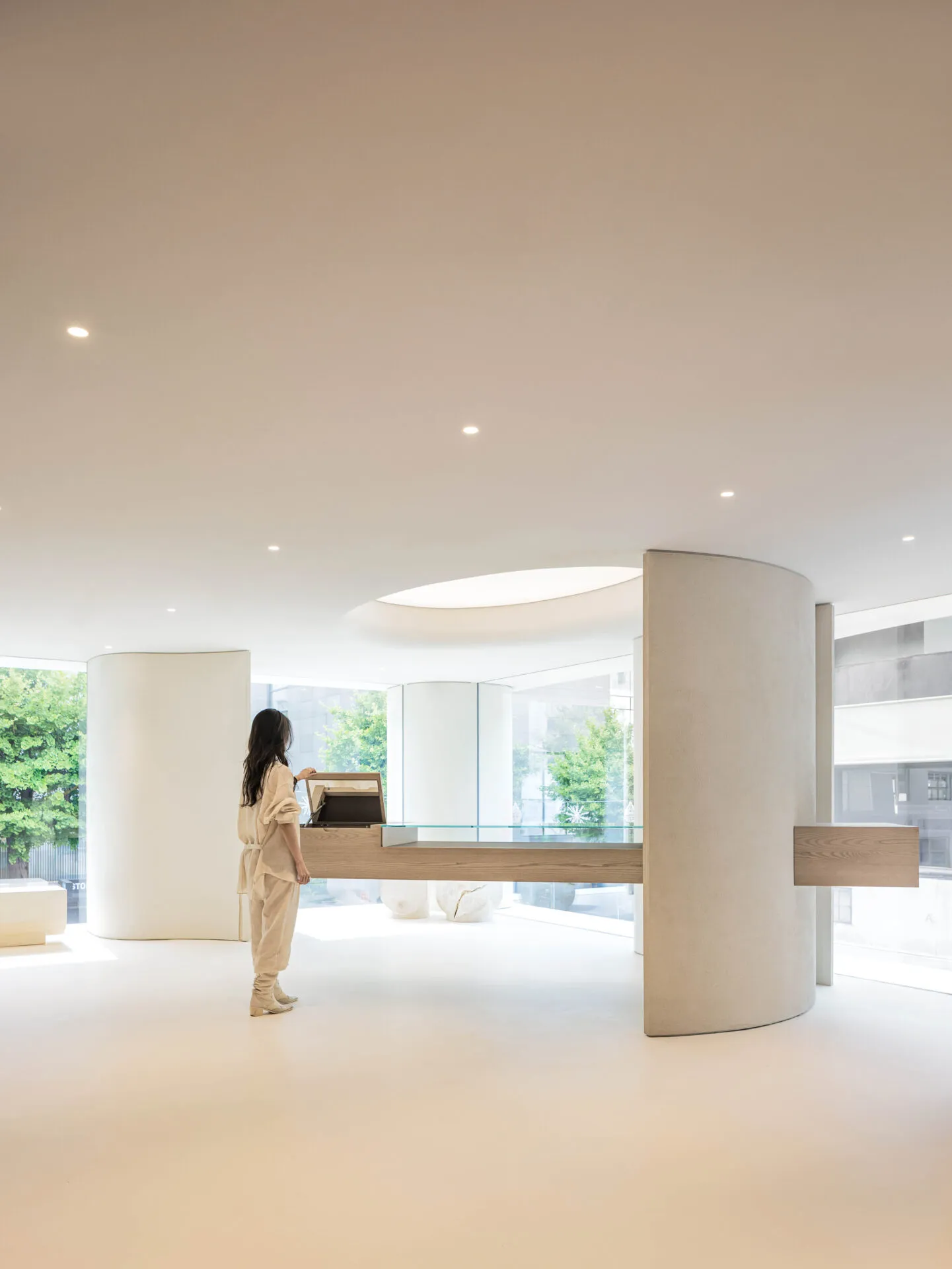 A modern interior space with concrete walls and a glass desk.