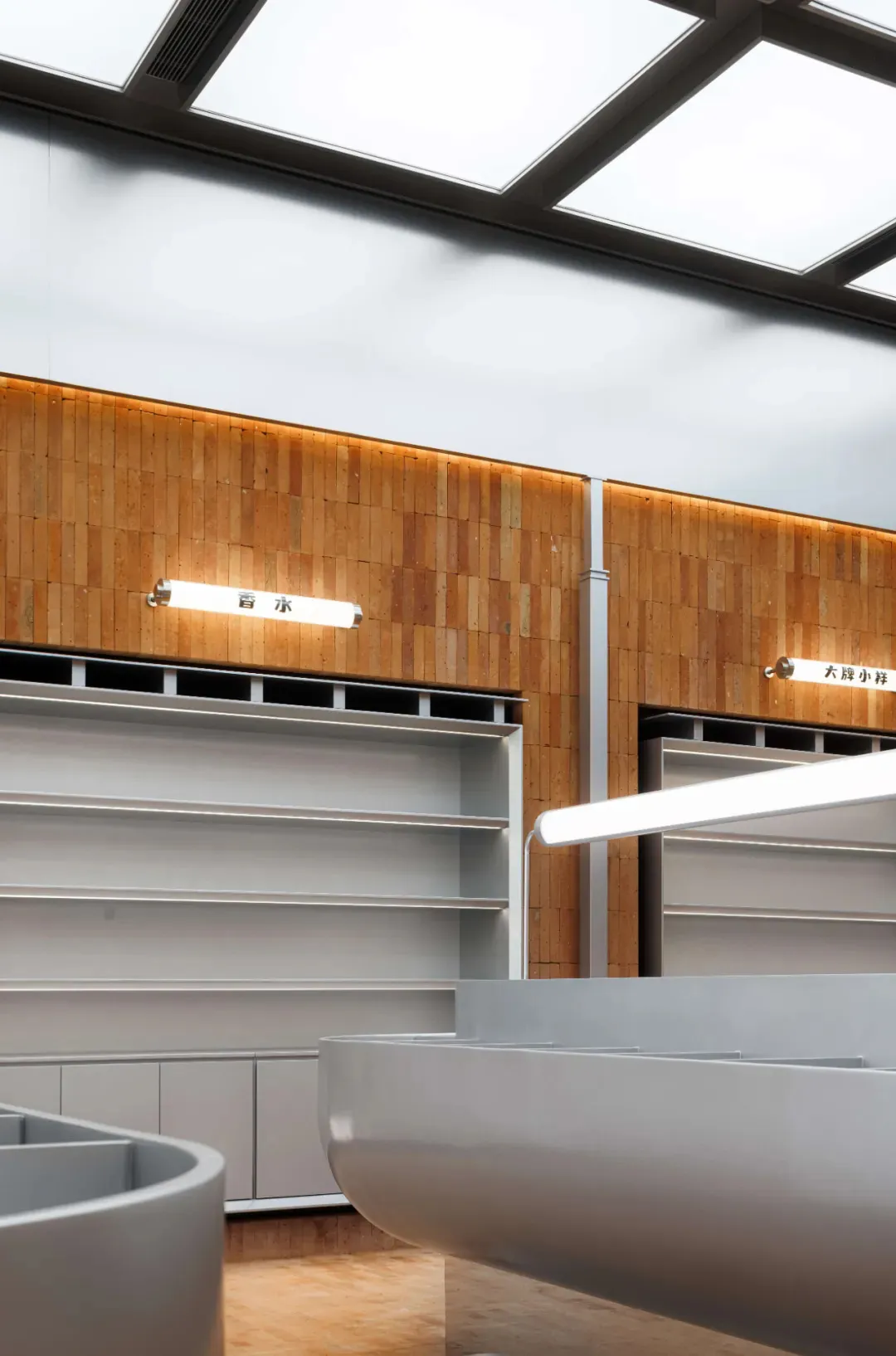 Empty shelves in a retail space featuring light wood cabinets and neutral colors.