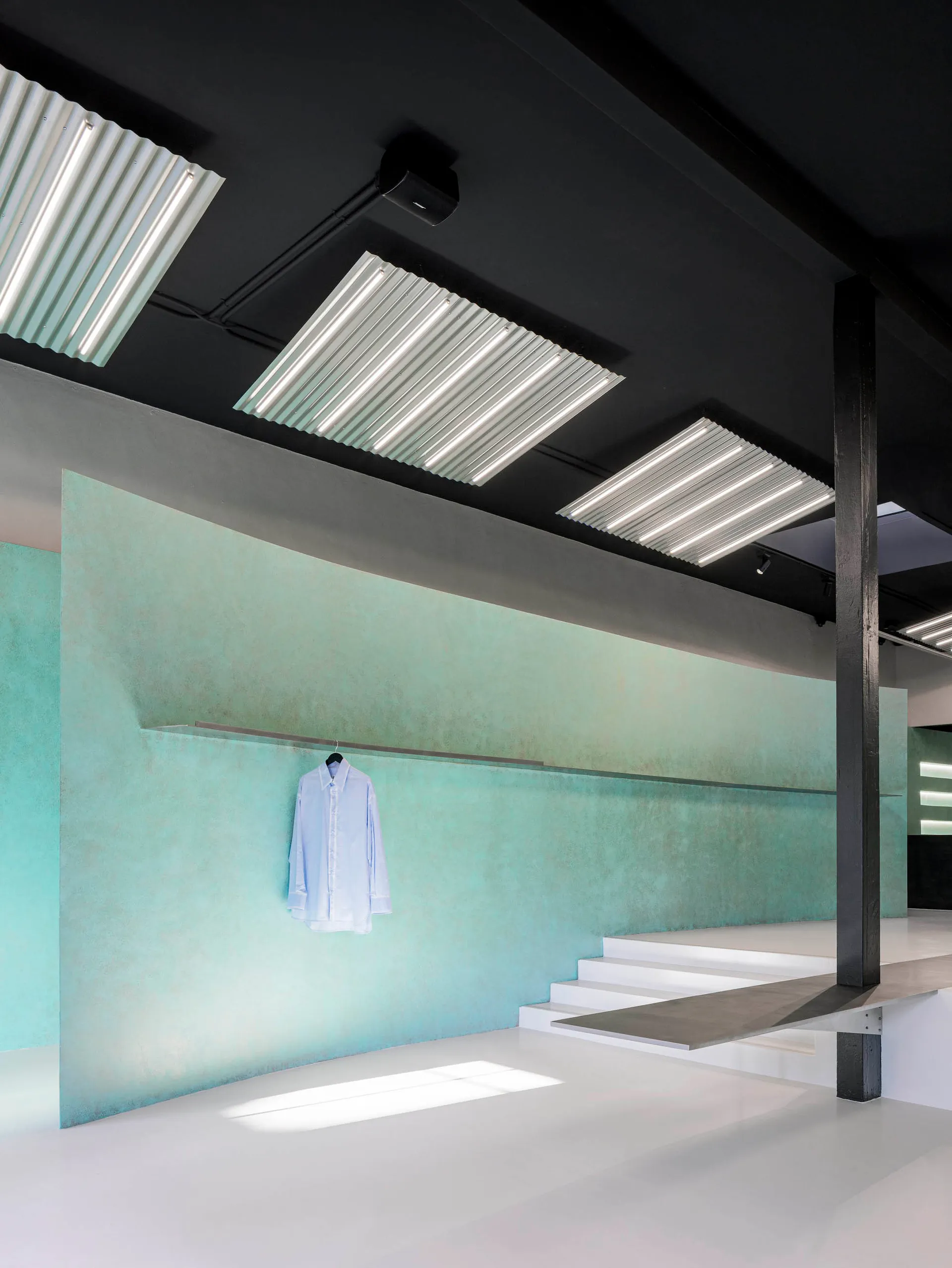 A modern clothing store with concrete walls and minimalist design.