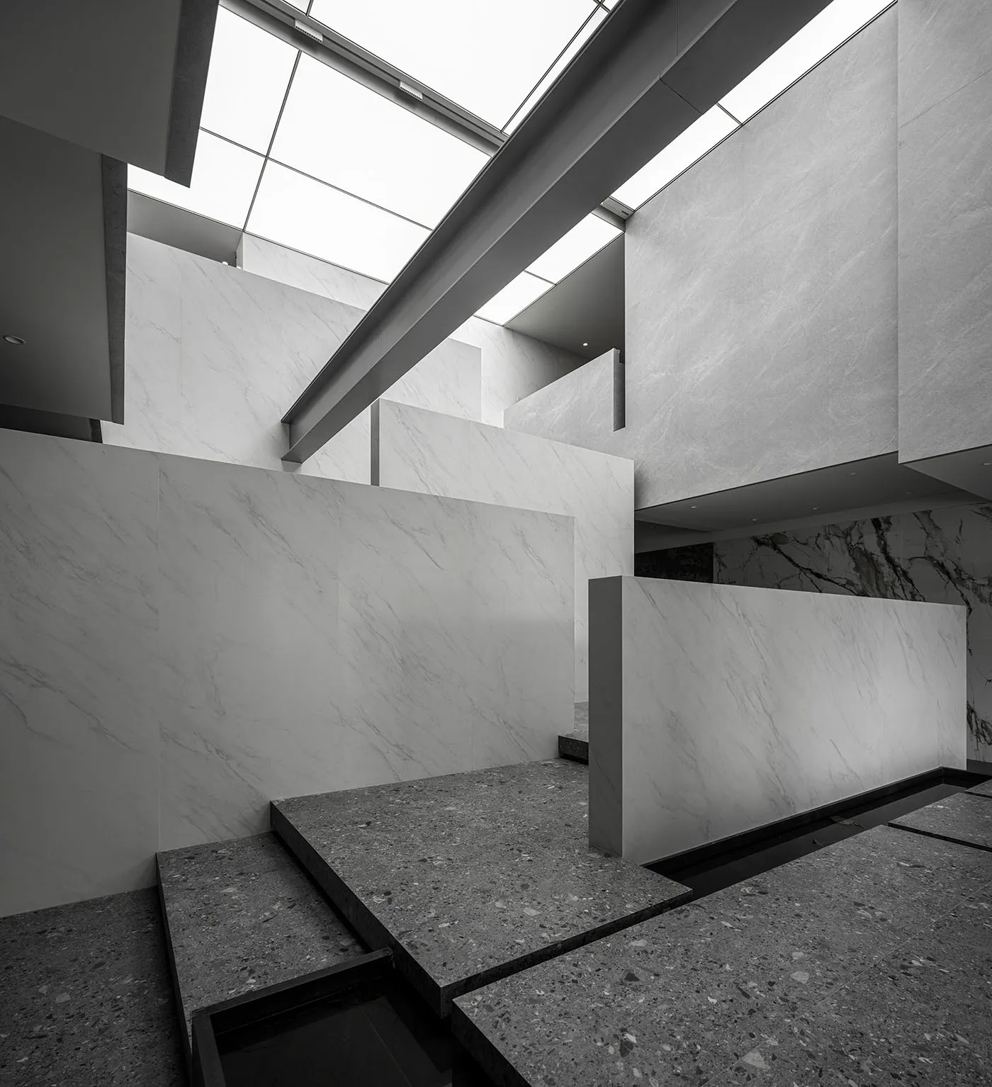 An interior space featuring white marble and concrete elements