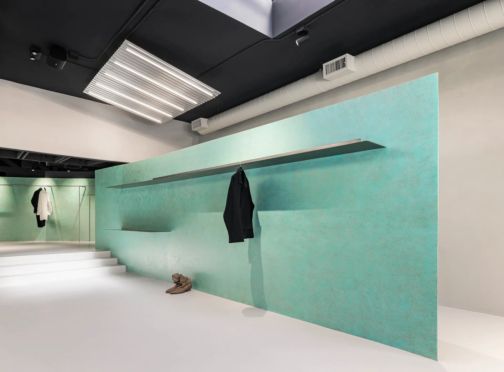 Modern metal display wall with minimalist design and sleek, reflective surfaces.