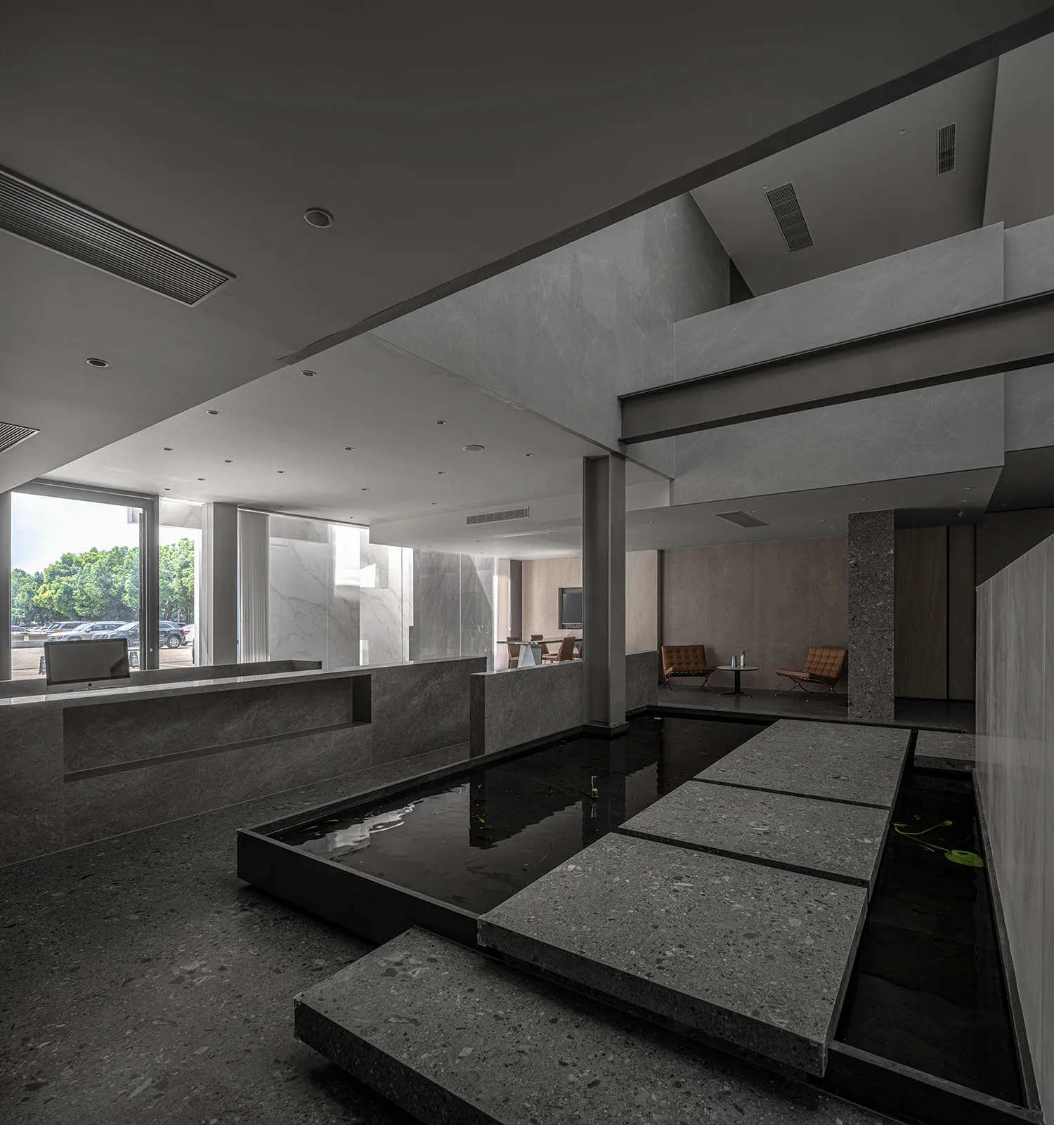 A modern office space featuring concrete and glass materials.