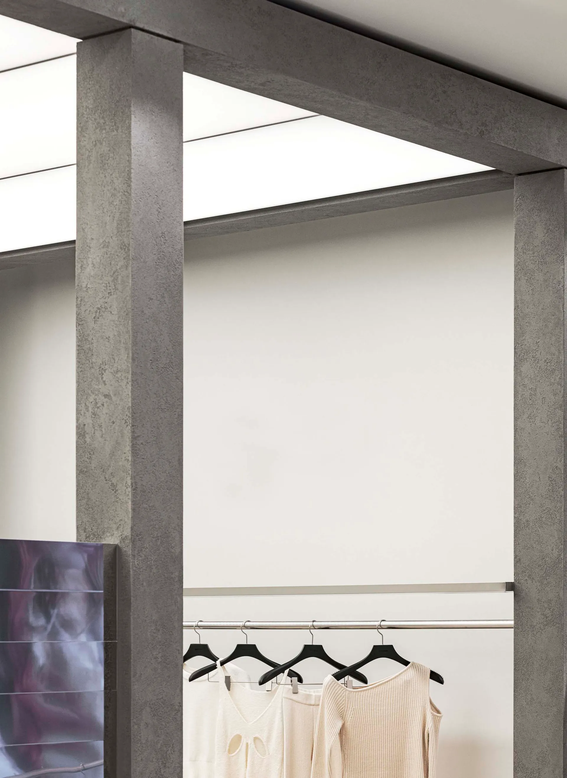 A clothing display featuring metallic hangers in a modern retail space.