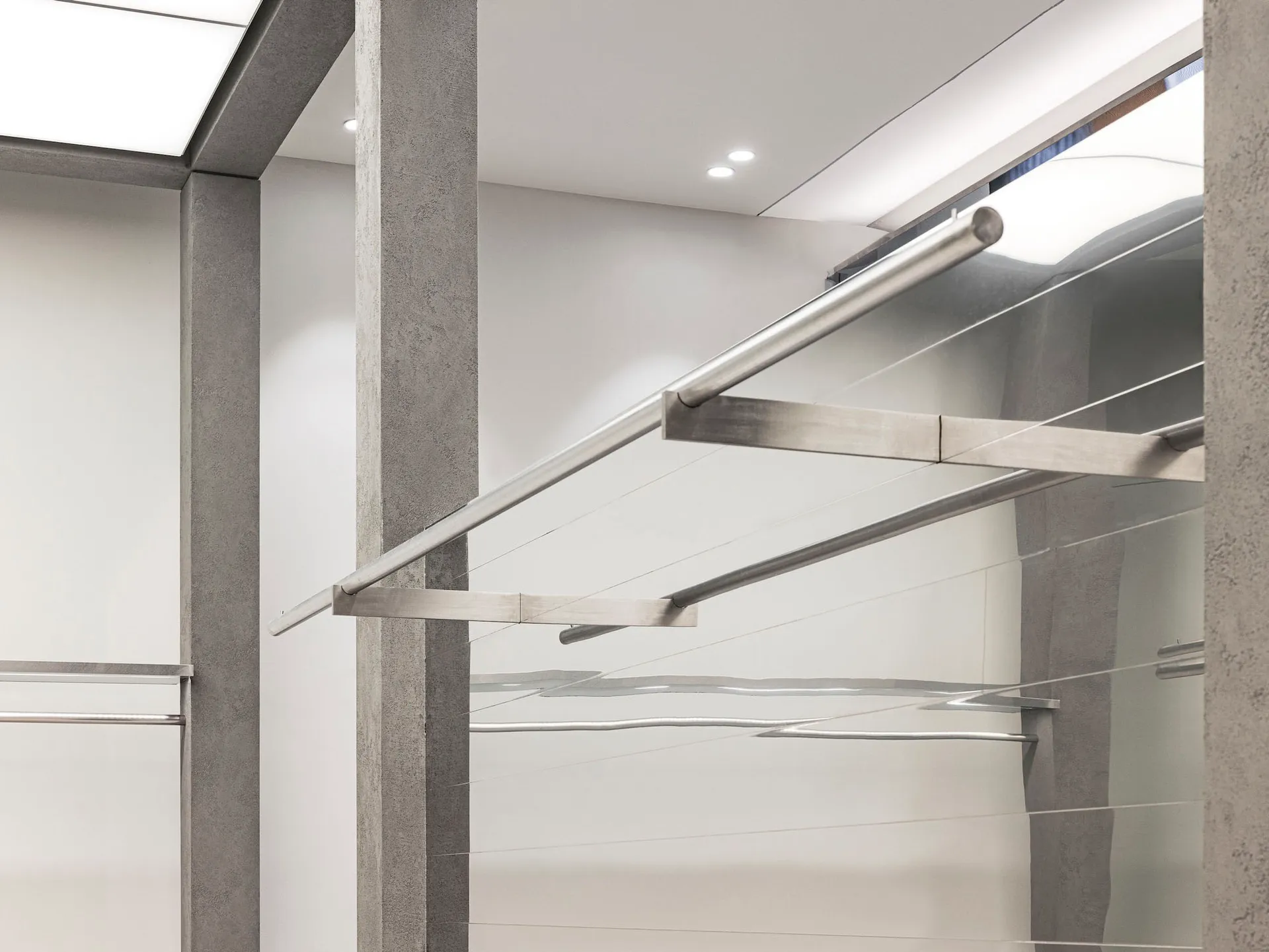 A minimalist interior space with concrete and metal structural bars.