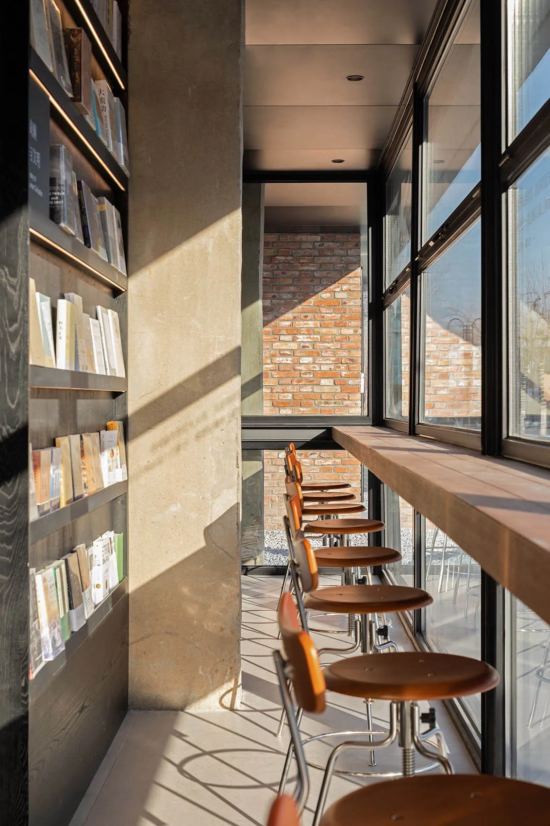 A modern coffee shop features a minimalist design with concrete, wood, and glass materials.