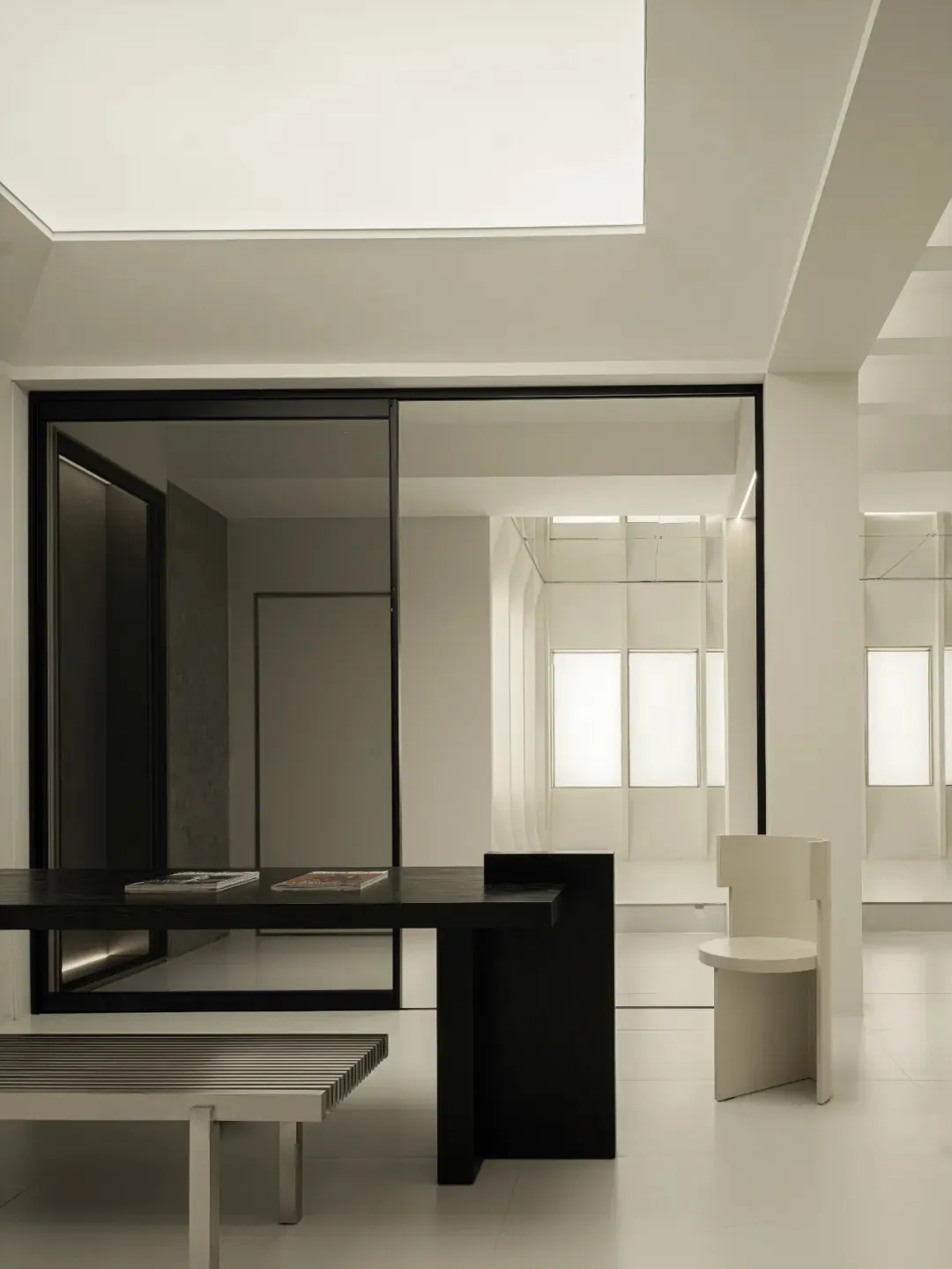 Modern minimalist office space featuring black and white furniture and decor.