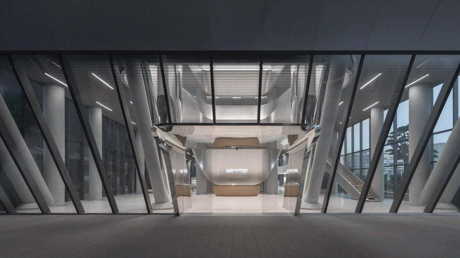 A modern office lobby featuring sleek metal, glass, and concrete elements