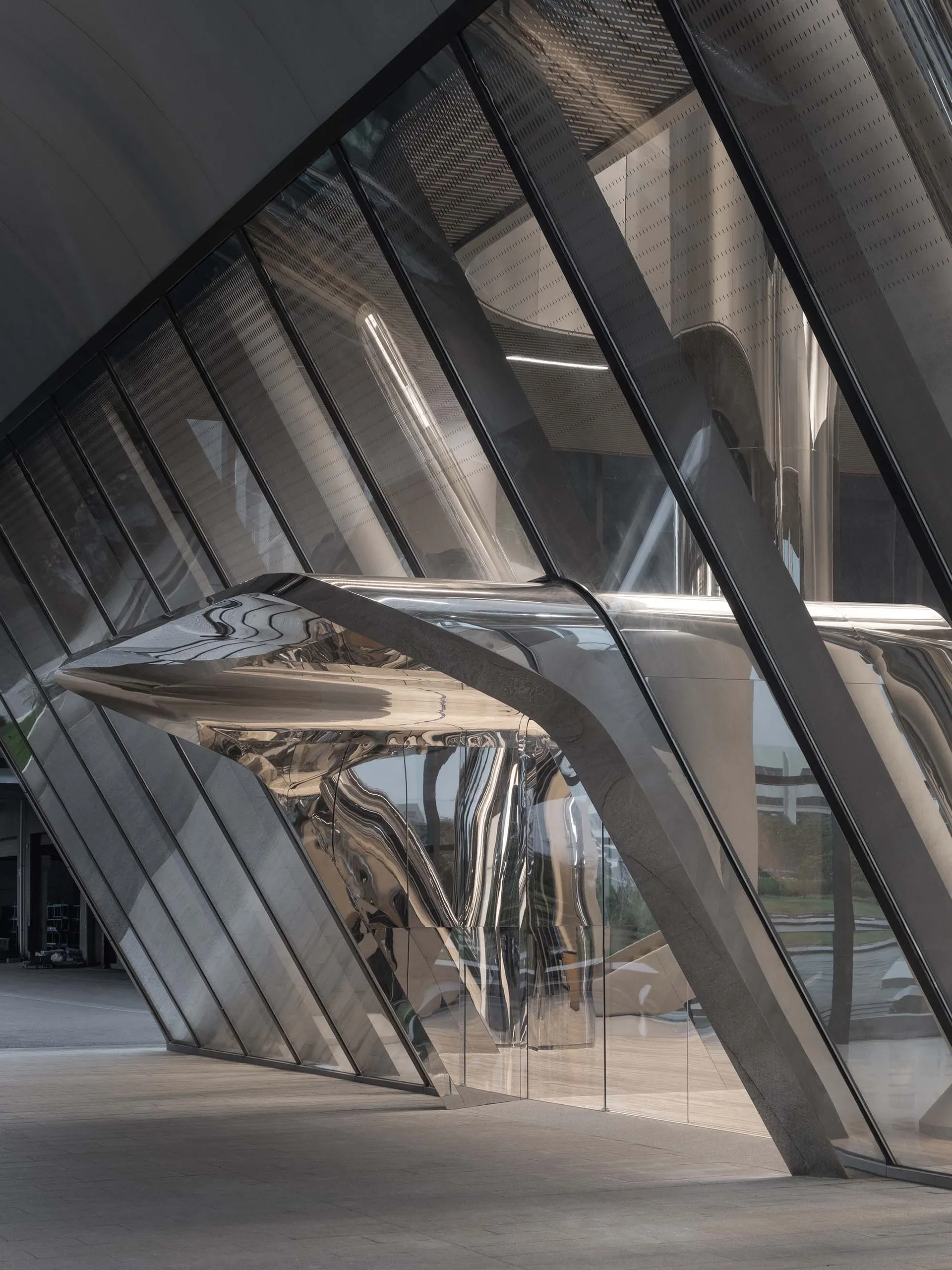 A futuristic architectural structure with metallic and glass elements.