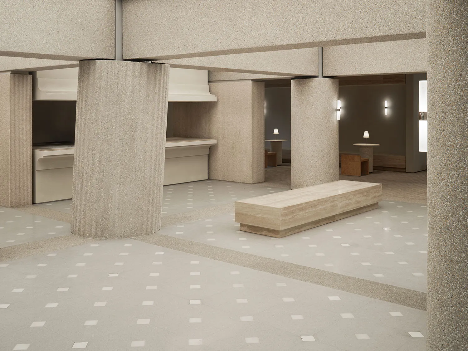 A modern minimalist lobby space featuring concrete materials.