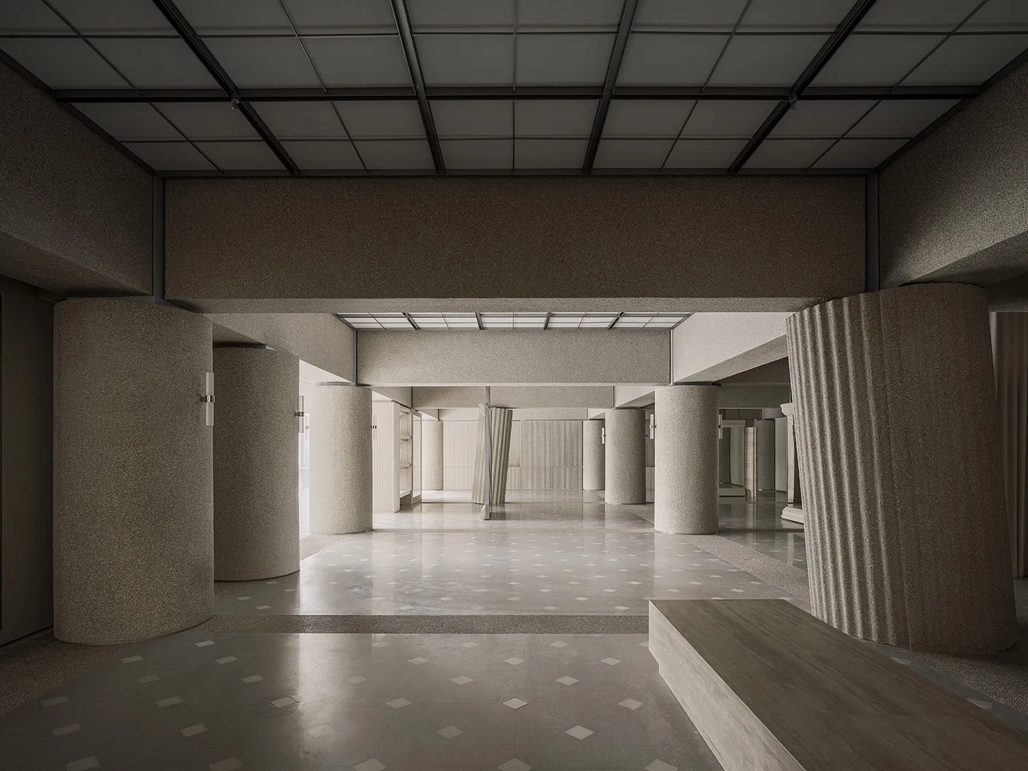A modern public interior featuring concrete columns and a patterned floor.