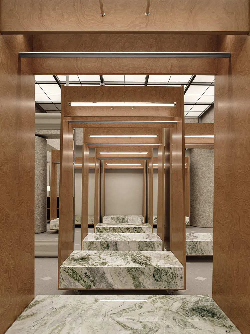 A retail dress fitting room with marble and wooden fixtures