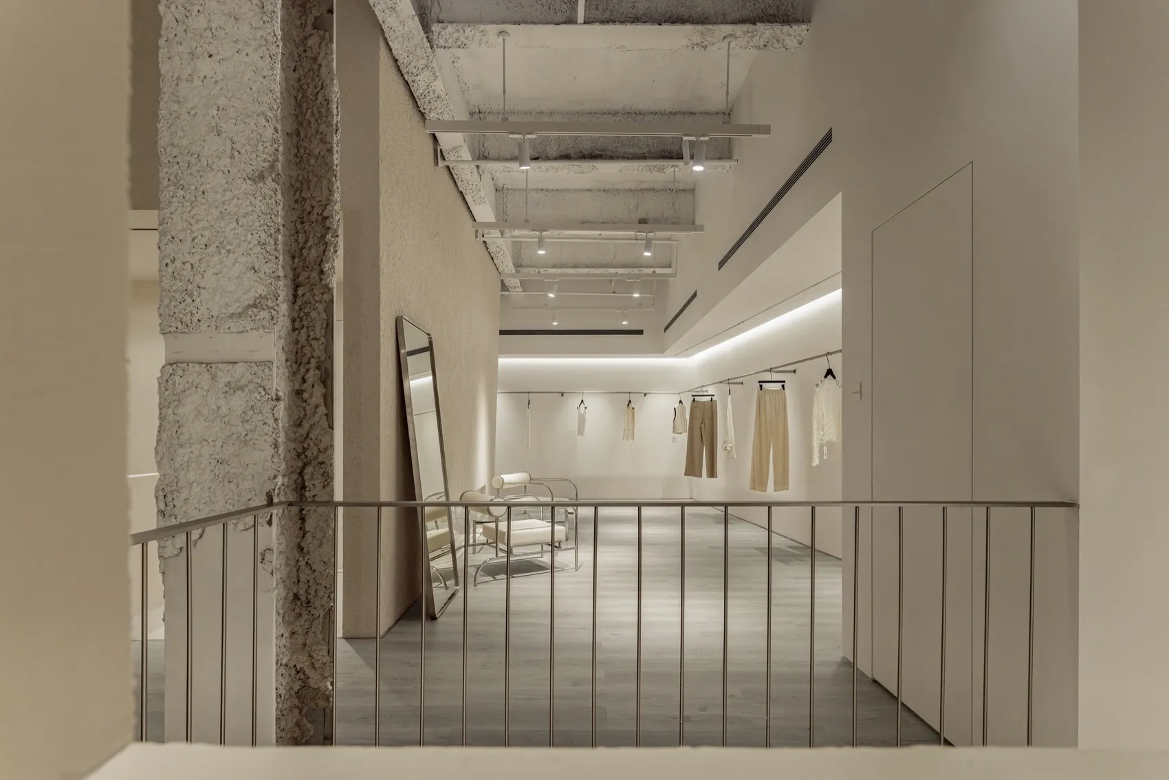 Minimalist retail space with concrete walls and ceiling.