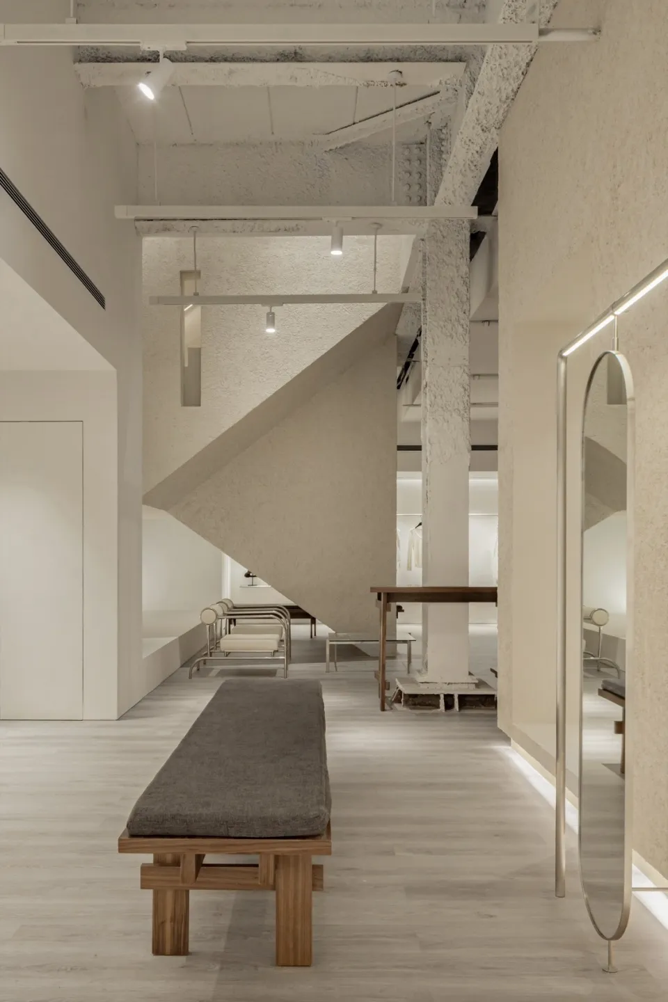 A modern retail space featuring elements of concrete, wood, and metal.