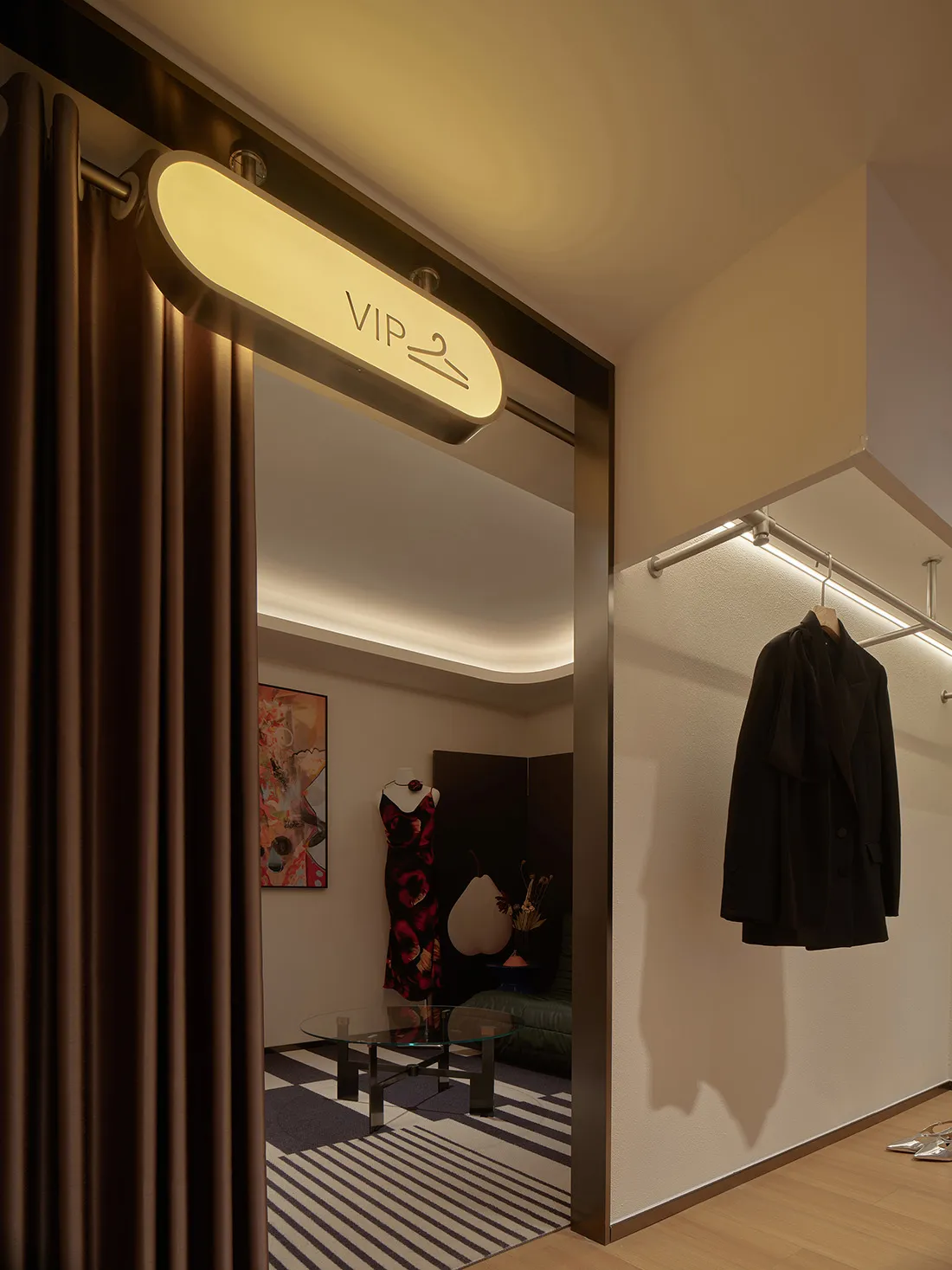 A luxurious VIP room with metallic textures in a high-end retail setting.