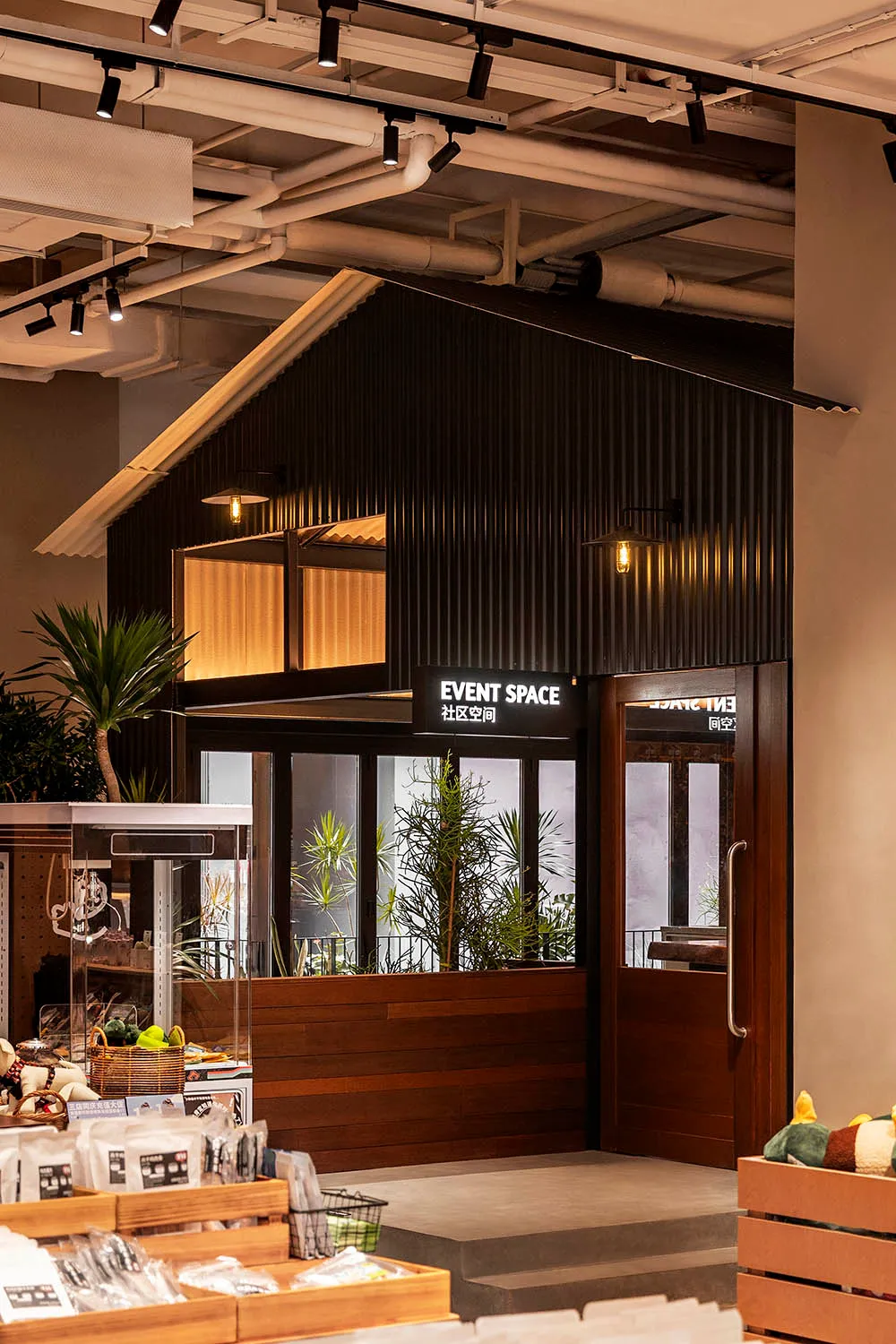 A modern event space entry with corrugated metal cladding and glass windows.
