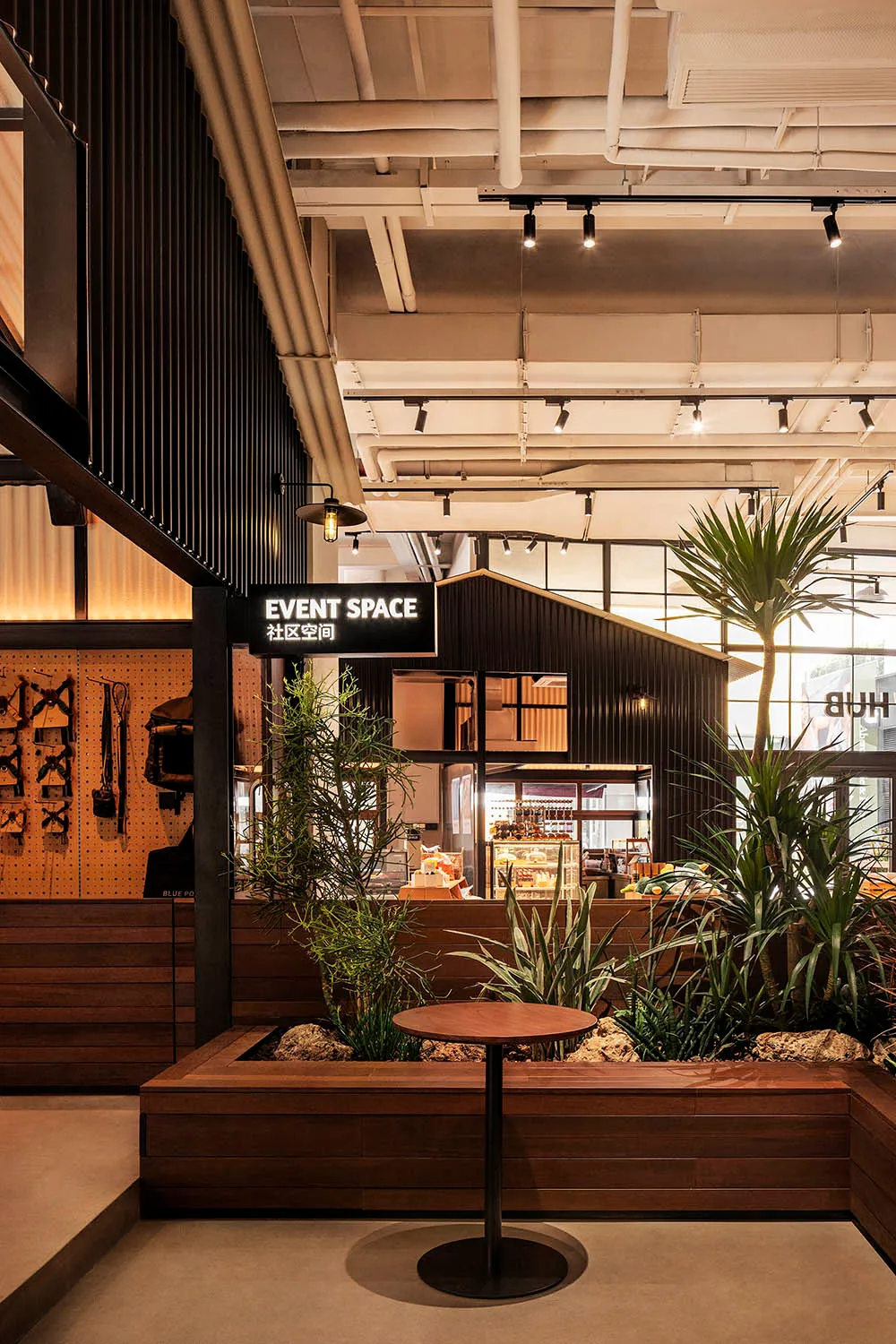 Industrial-themed restaurant event space featuring wood accents, concrete flooring, and metal accents.