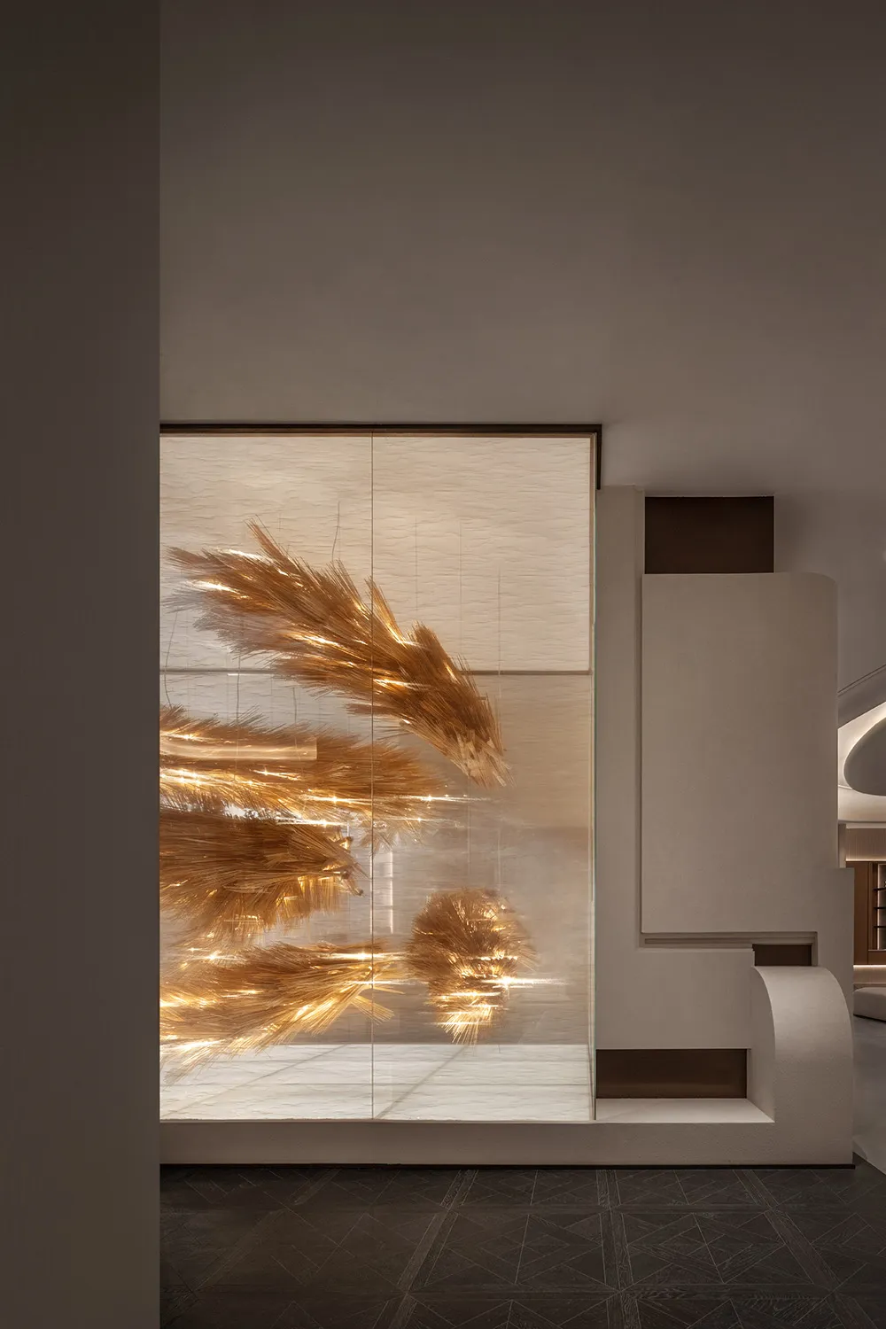 A minimalist interior space featuring a metallic decorative installation.