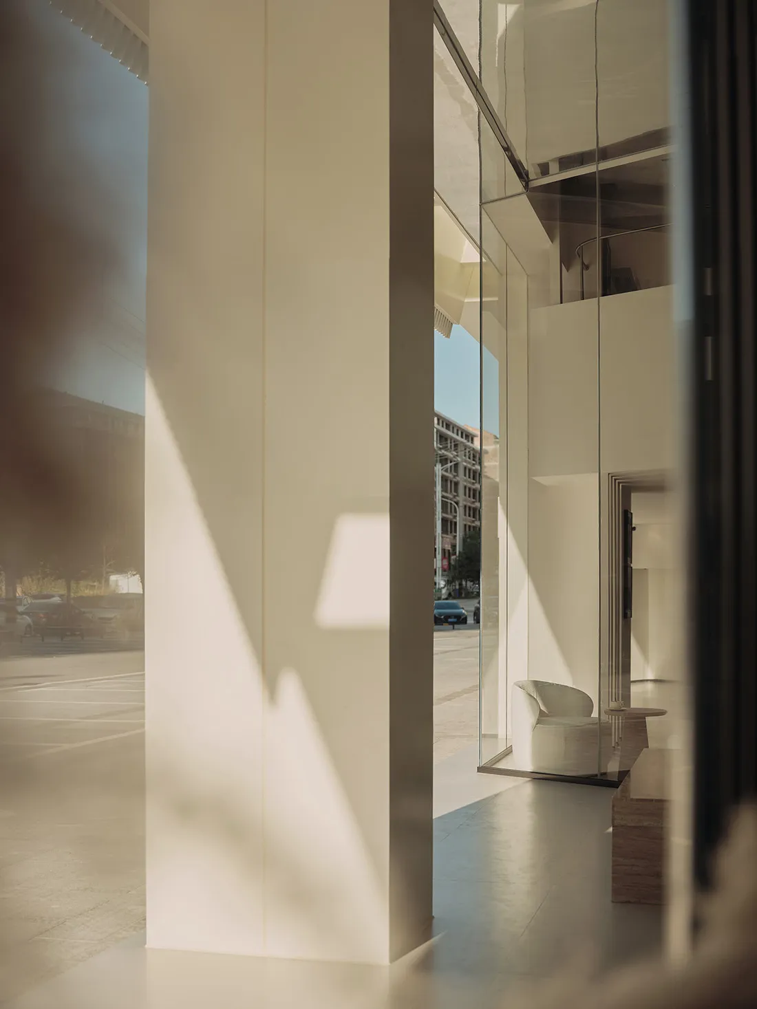 A minimalist retail storefront featuring glass doors.