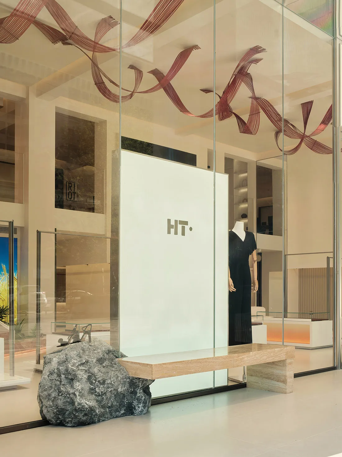 Modern retail storefront featuring glass and stone materials.