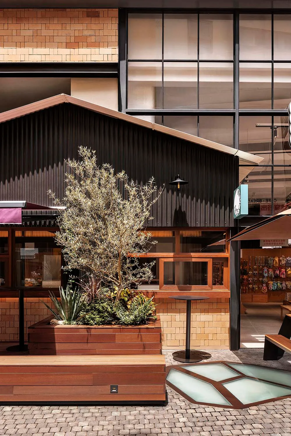 A retail storefront with wooden panels and glass windows.