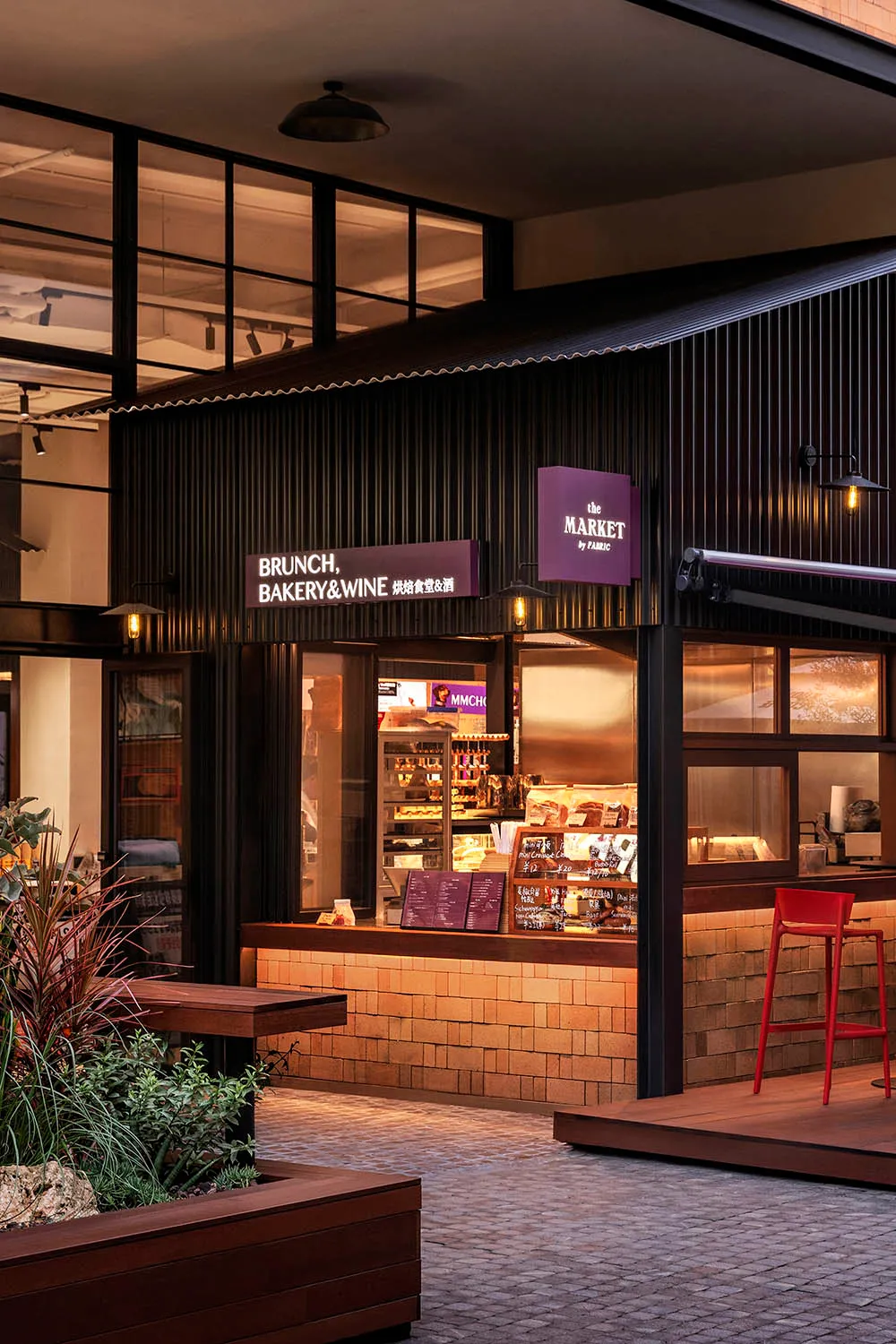 A modern industrial retail store featuring black metal, brick, and large windows.