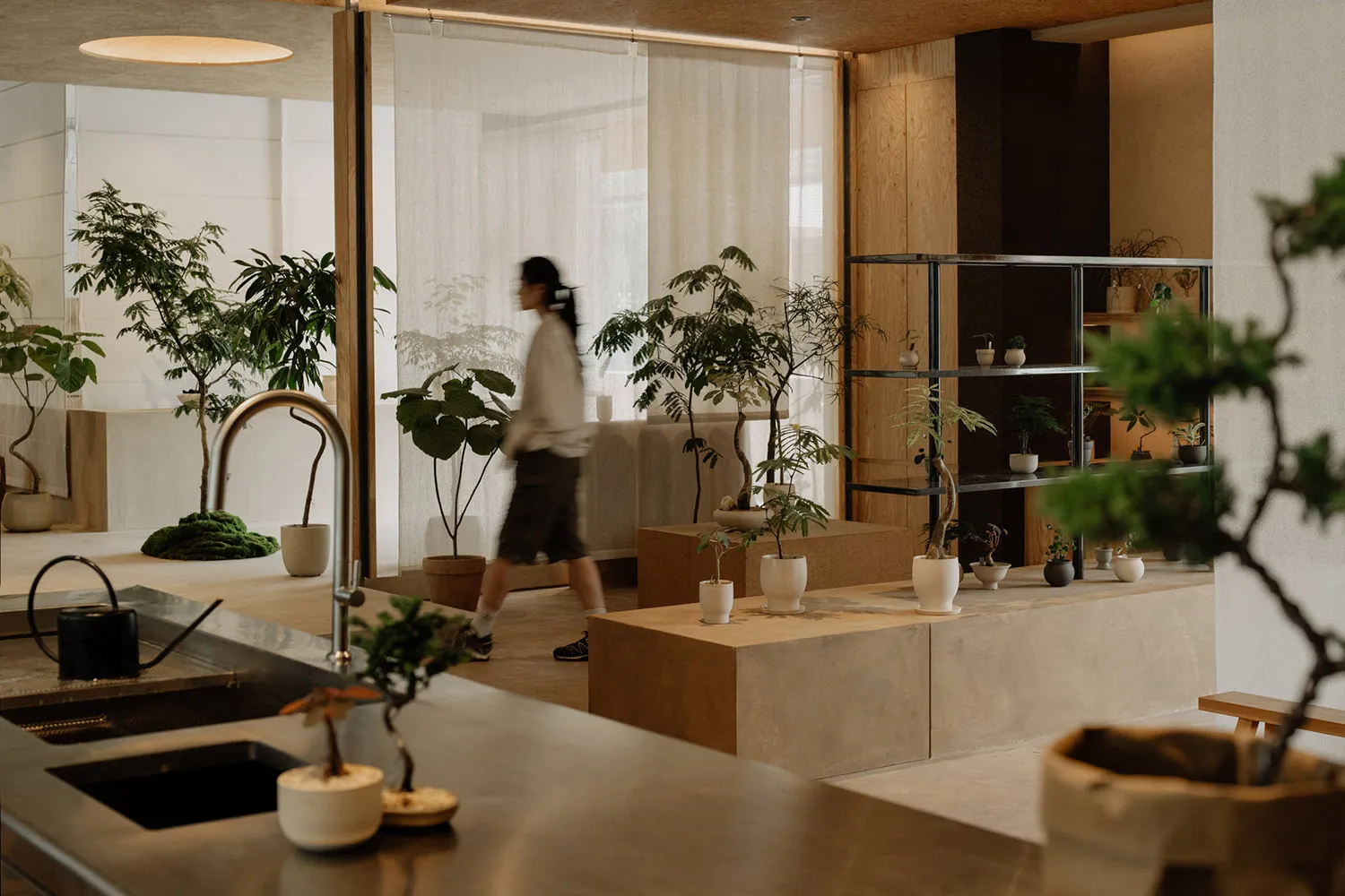 A modern office space with minimalist design featuring concrete and wooden elements.