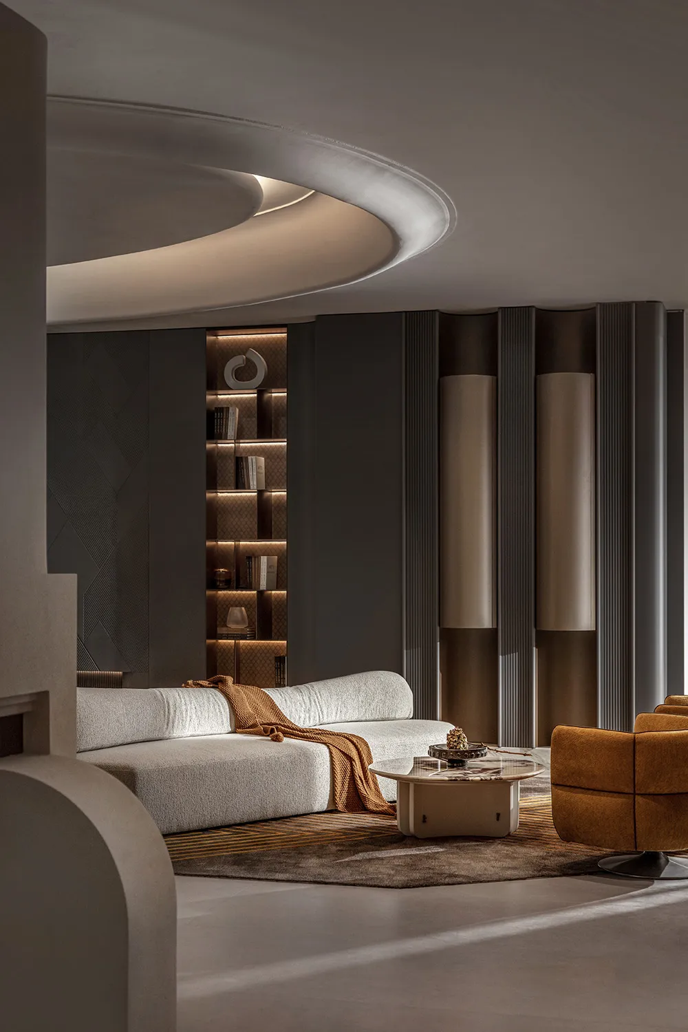 Modern living room with concrete walls, leather furniture, and metal accents.