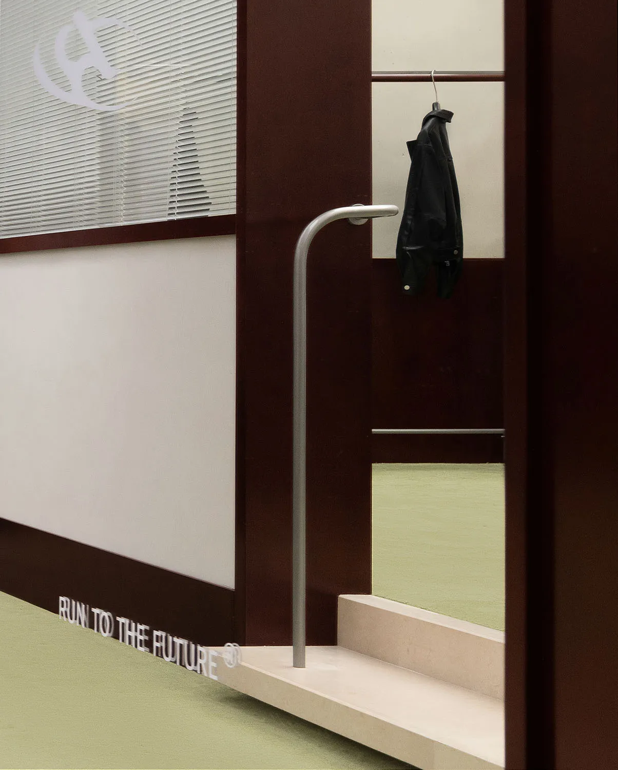 A metal clothing rack hanging in a modern industrial-style room.