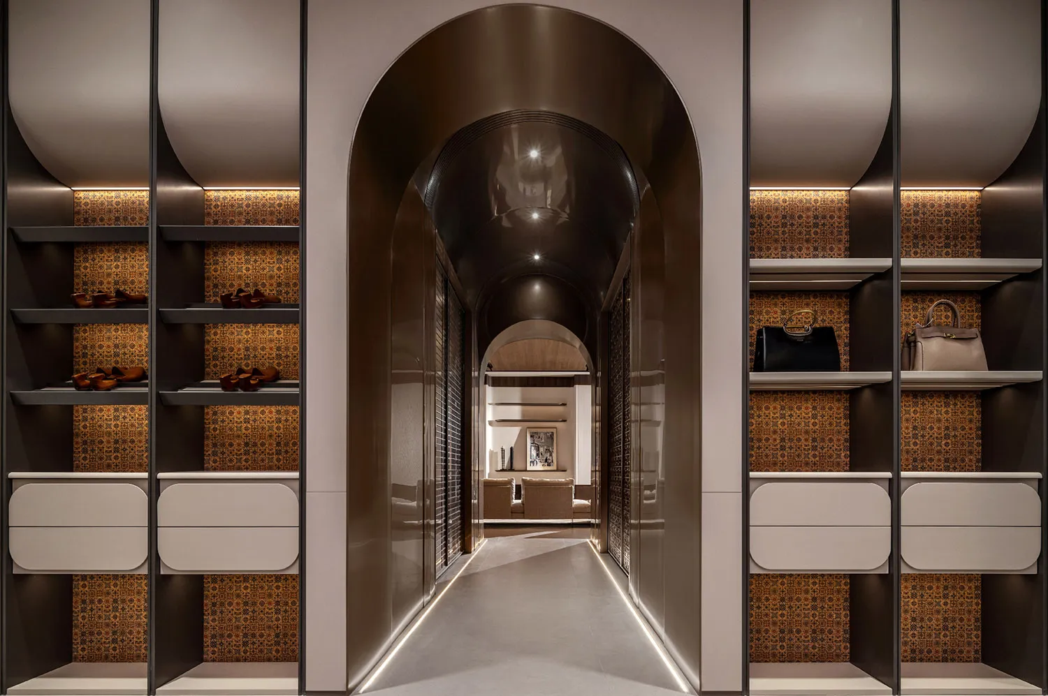 Clothing storage corridor featuring metallic shelving, patterned tiles, and illuminated walkway.