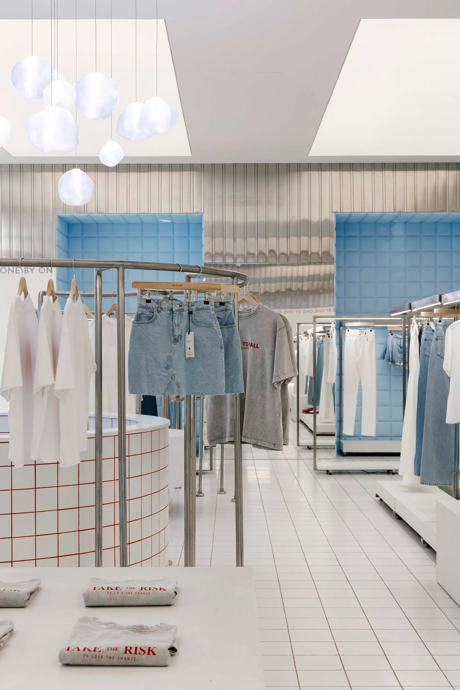 A modern retail space featuring minimalist design with tile flooring, concrete accents, and wooden fixtures.