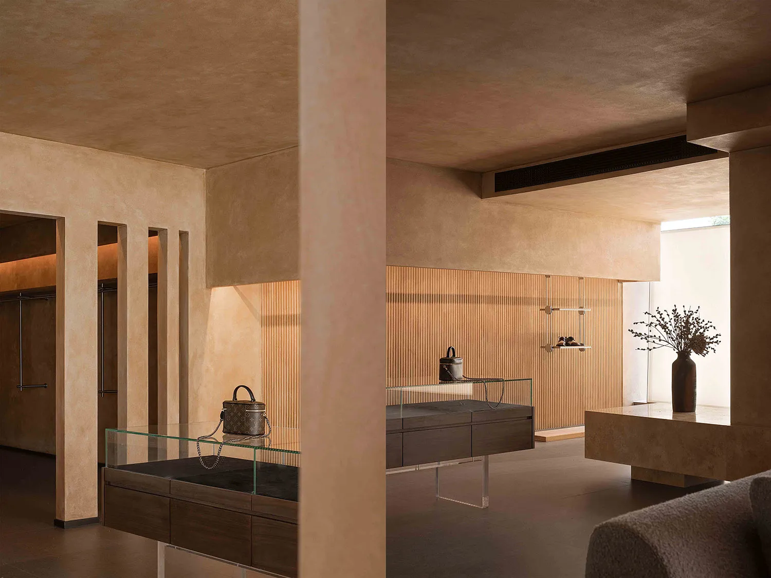 Interior view of a modern retail shop featuring a display counter made of marble with wood accents.