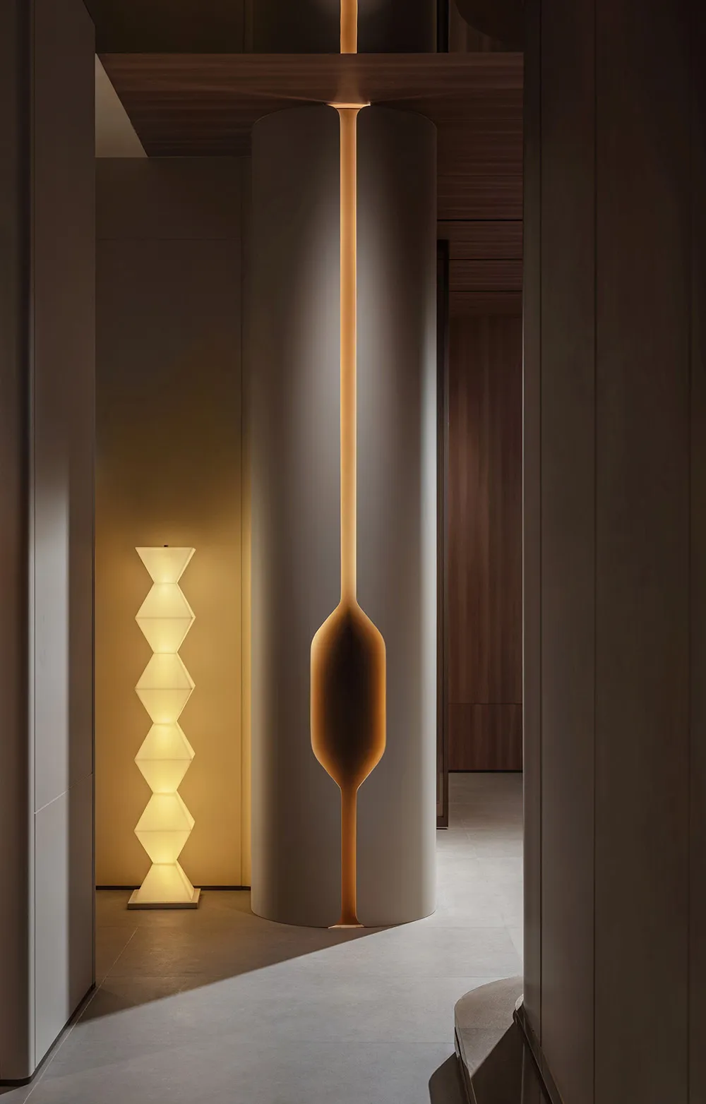 Modern minimalist interior space featuring contemporary floor lamps with abstract geometric shapes.