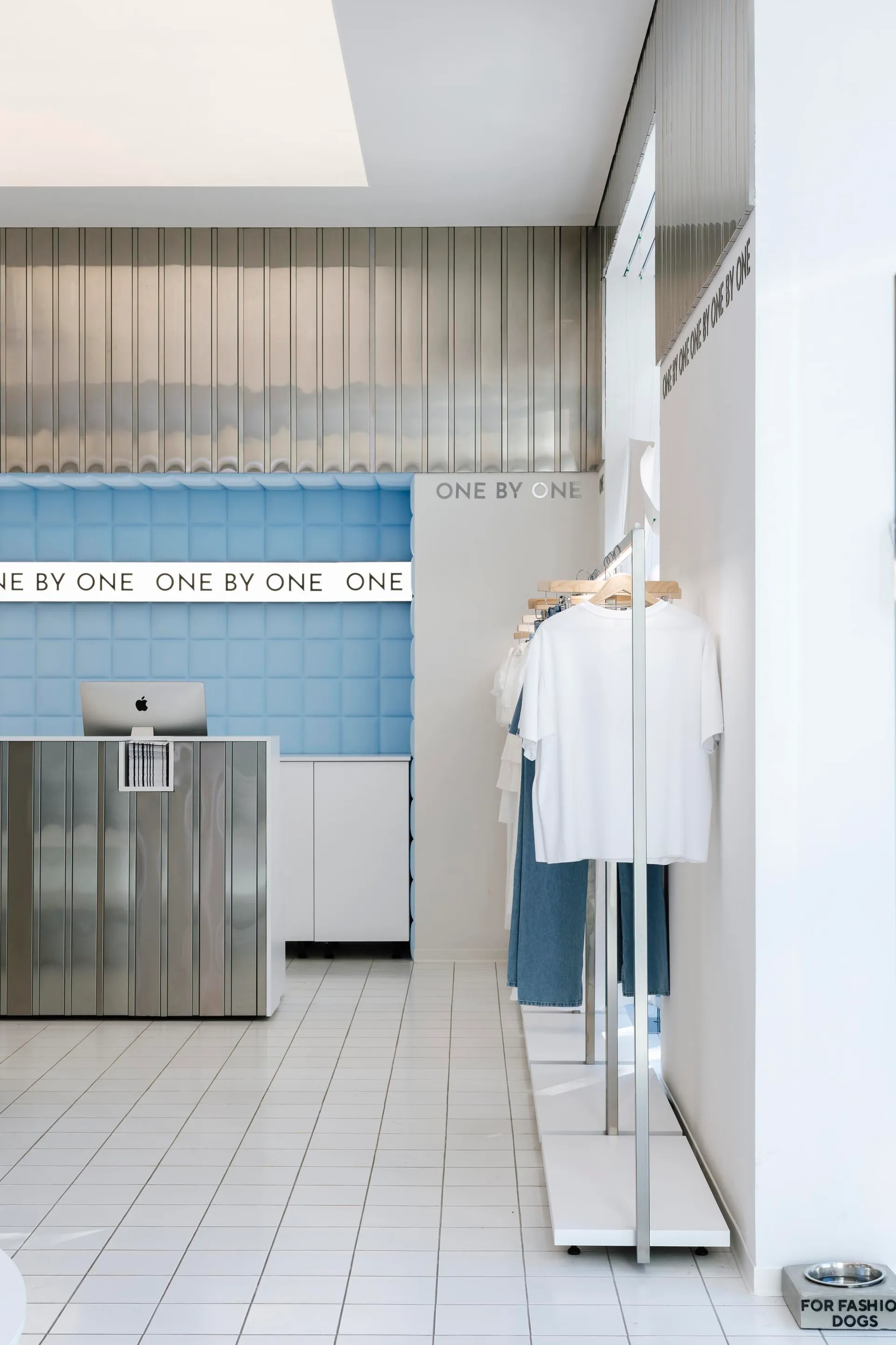 A modern retail storefront with white tiles and minimalist design.