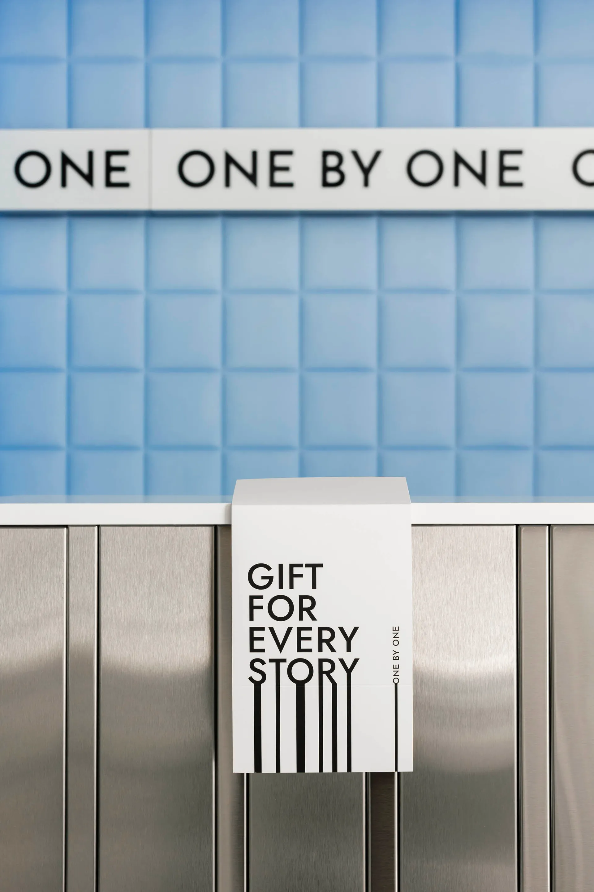 A metal and tile storefront with signage reading 'Gift for Every Story'.