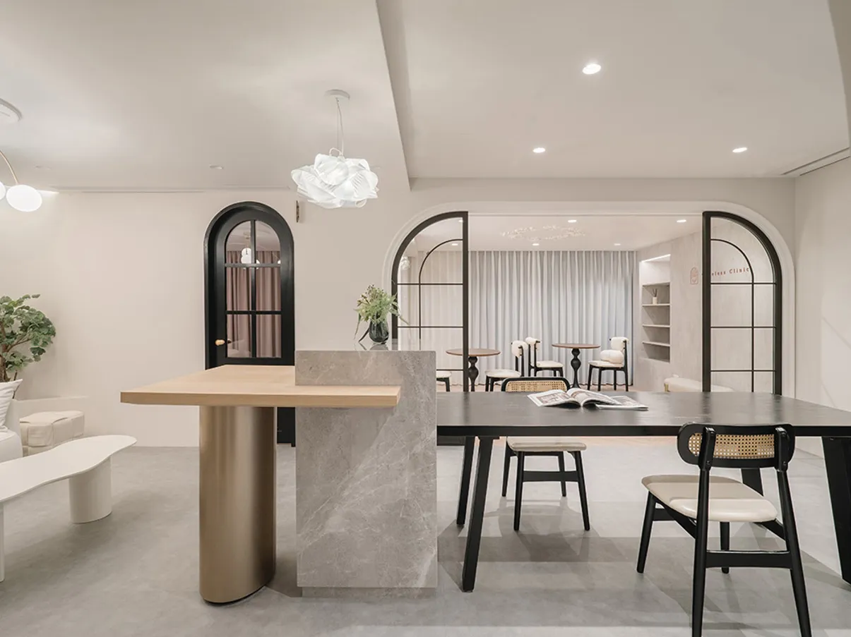 Modern hospitality interior featuring a minimalist design with marble and concrete elements.