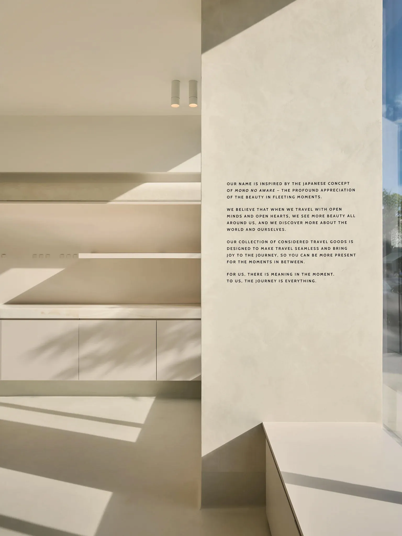 A modern travel goods store featuring minimalist design with concrete and glass materials.