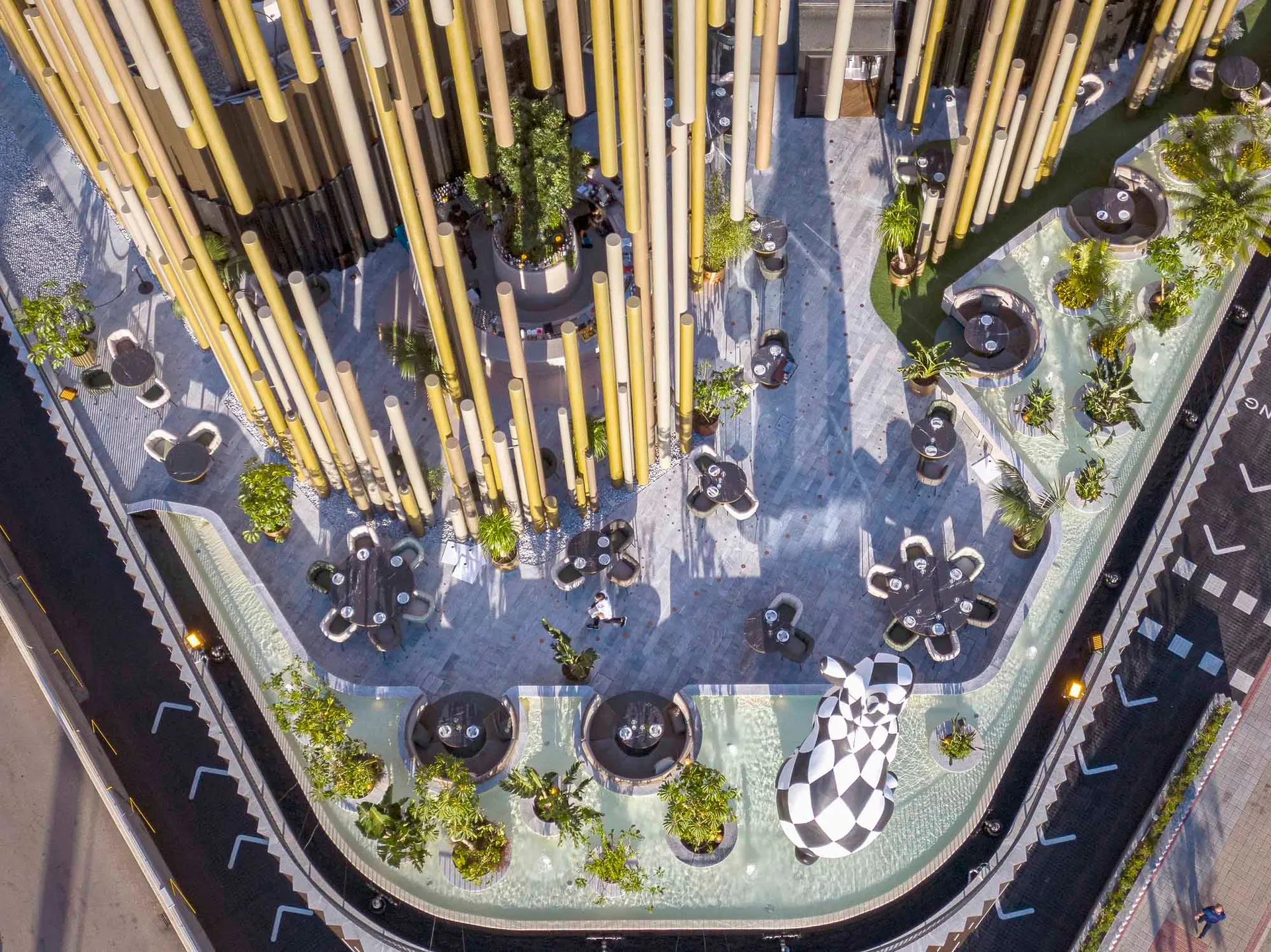 A modern urban green space featuring concrete and wooden elements.