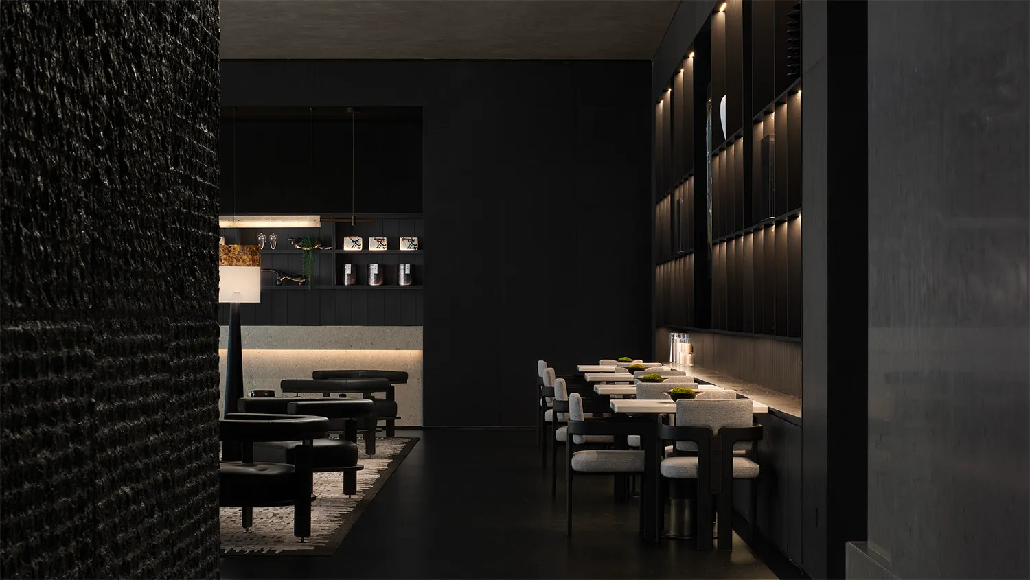 A modern restaurant interior with minimalist design and black concrete walls.