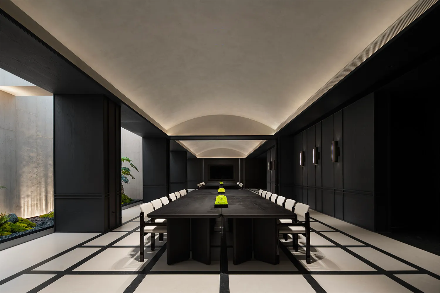 A spacious, modern conference room with a sleek, concrete design.