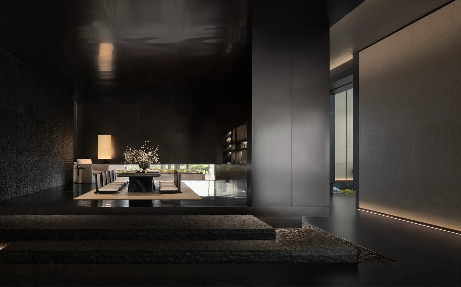 A modern living room with a concrete floor, glass walls, and minimalist decor.