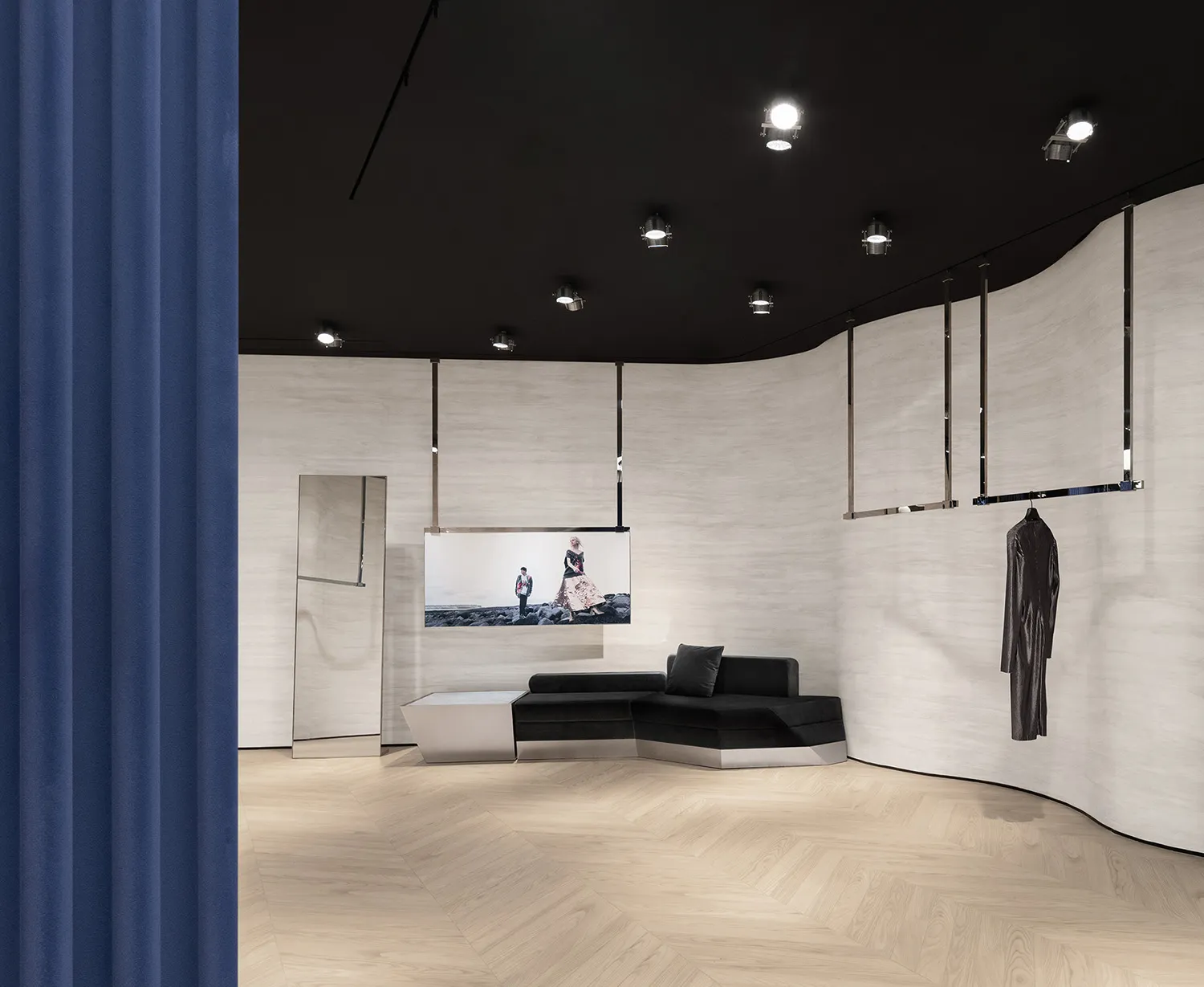 A modern retail storefront featuring metallic and fabric elements on a wooden floor.