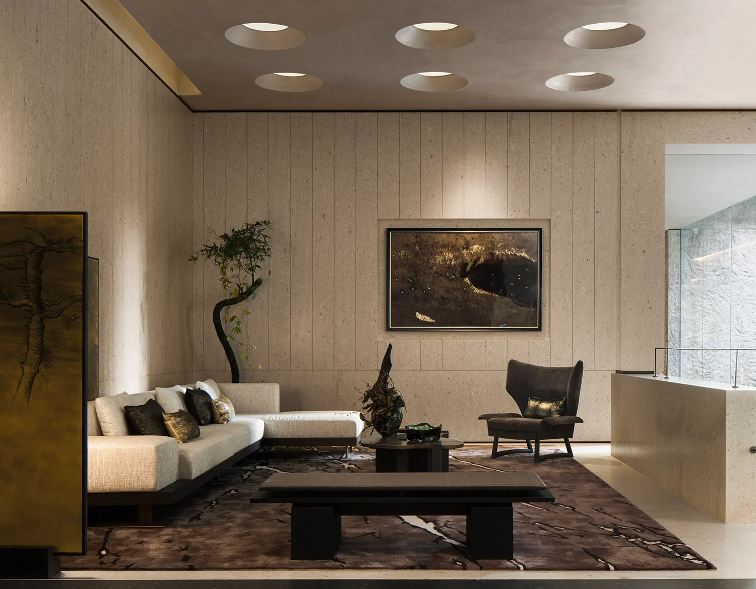 Contemporary living room featuring luxury materials such as concrete, leather, and glass.