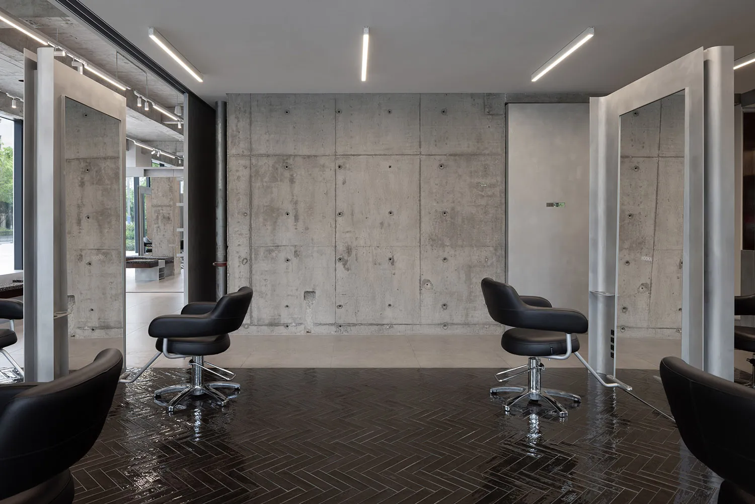 Minimalist interior design featuring modern furniture, concrete walls, glass panels, and metallic accents.