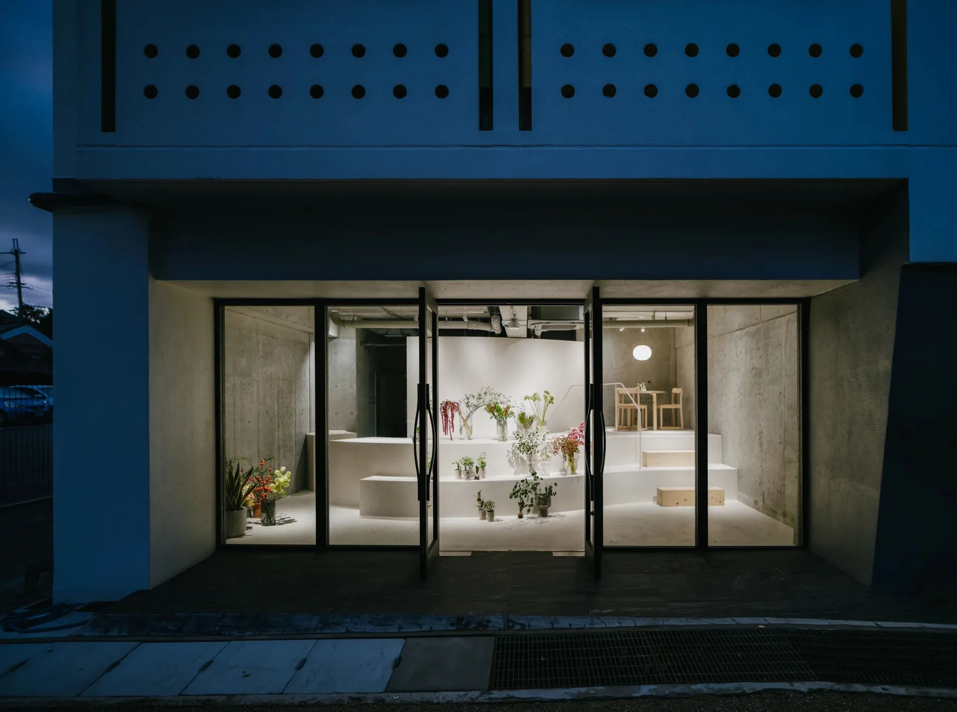 A modern retail storefront with concrete walls and a minimalist design.