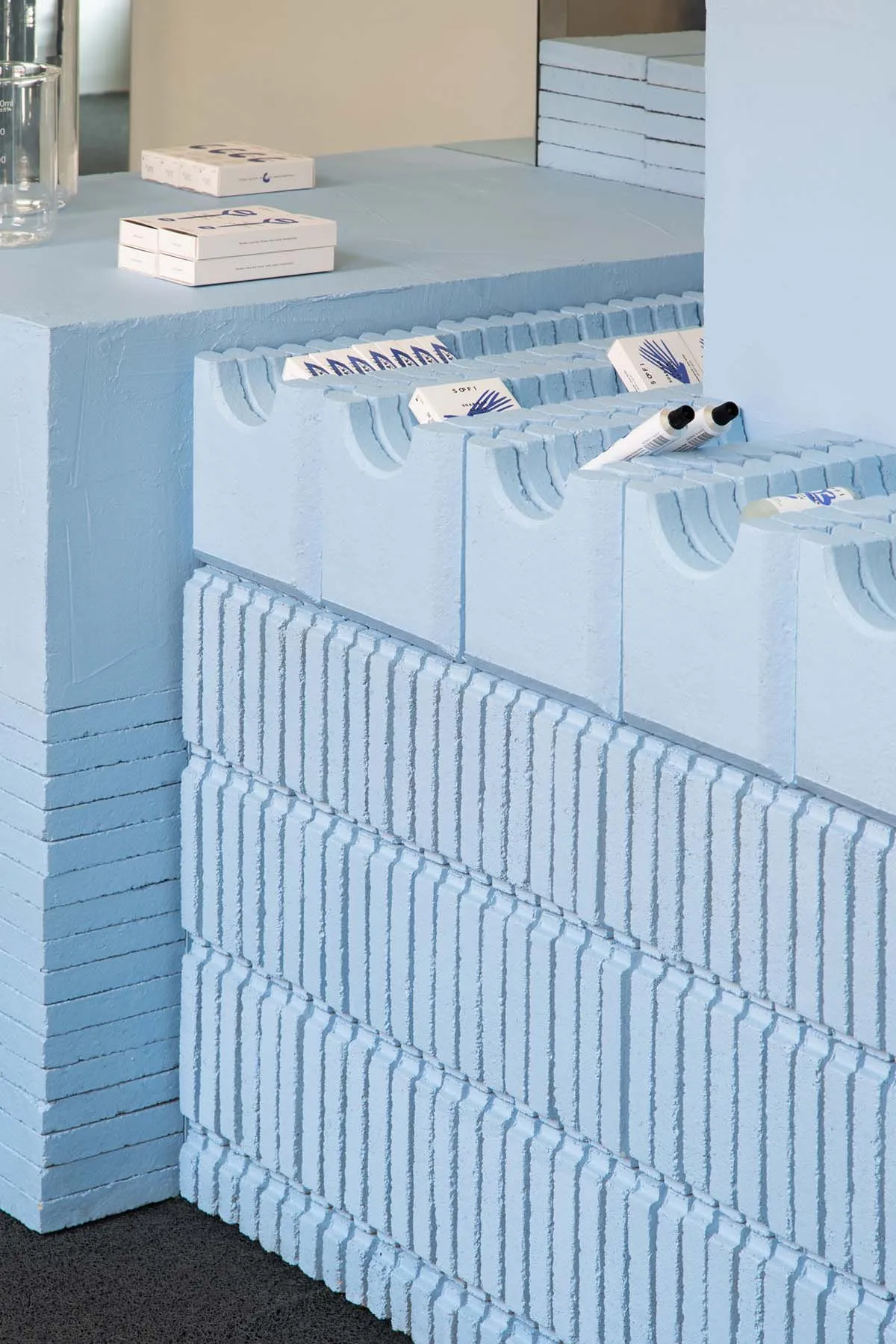 Blue concrete products displayed on a shelf