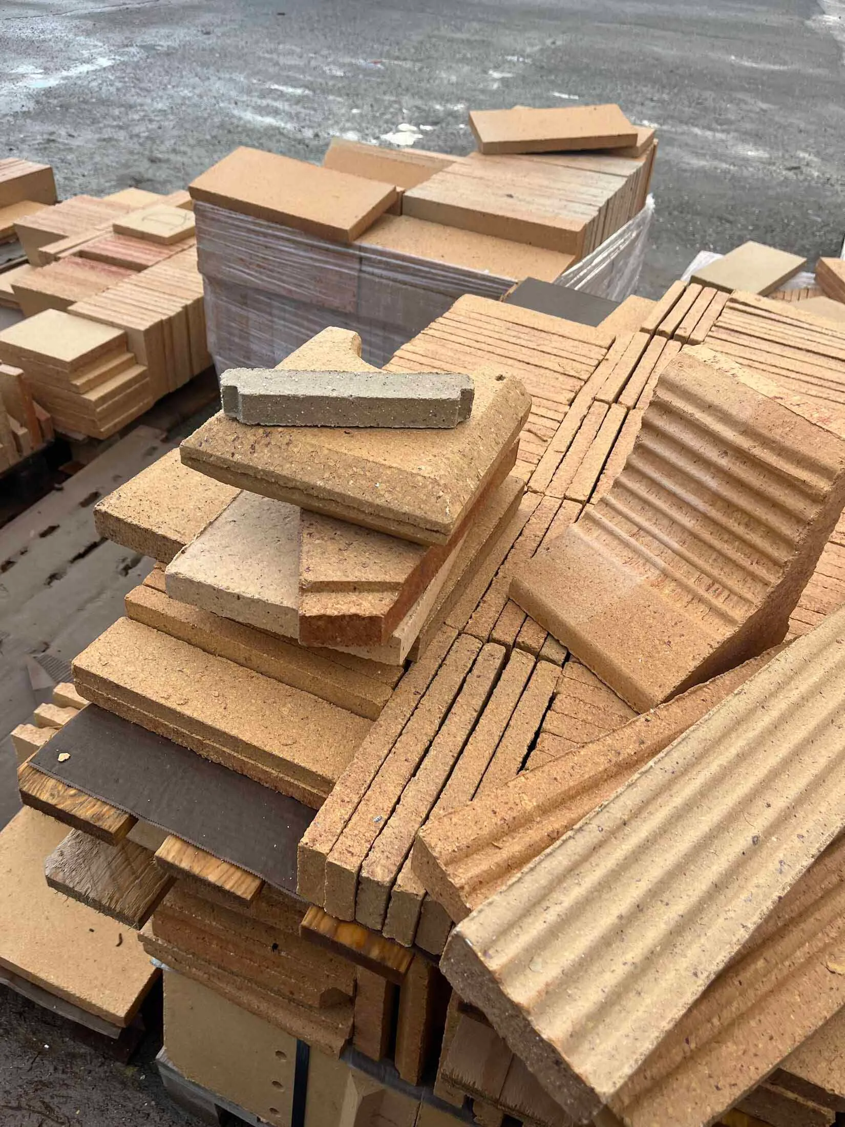 A stack of various ceramic construction materials.