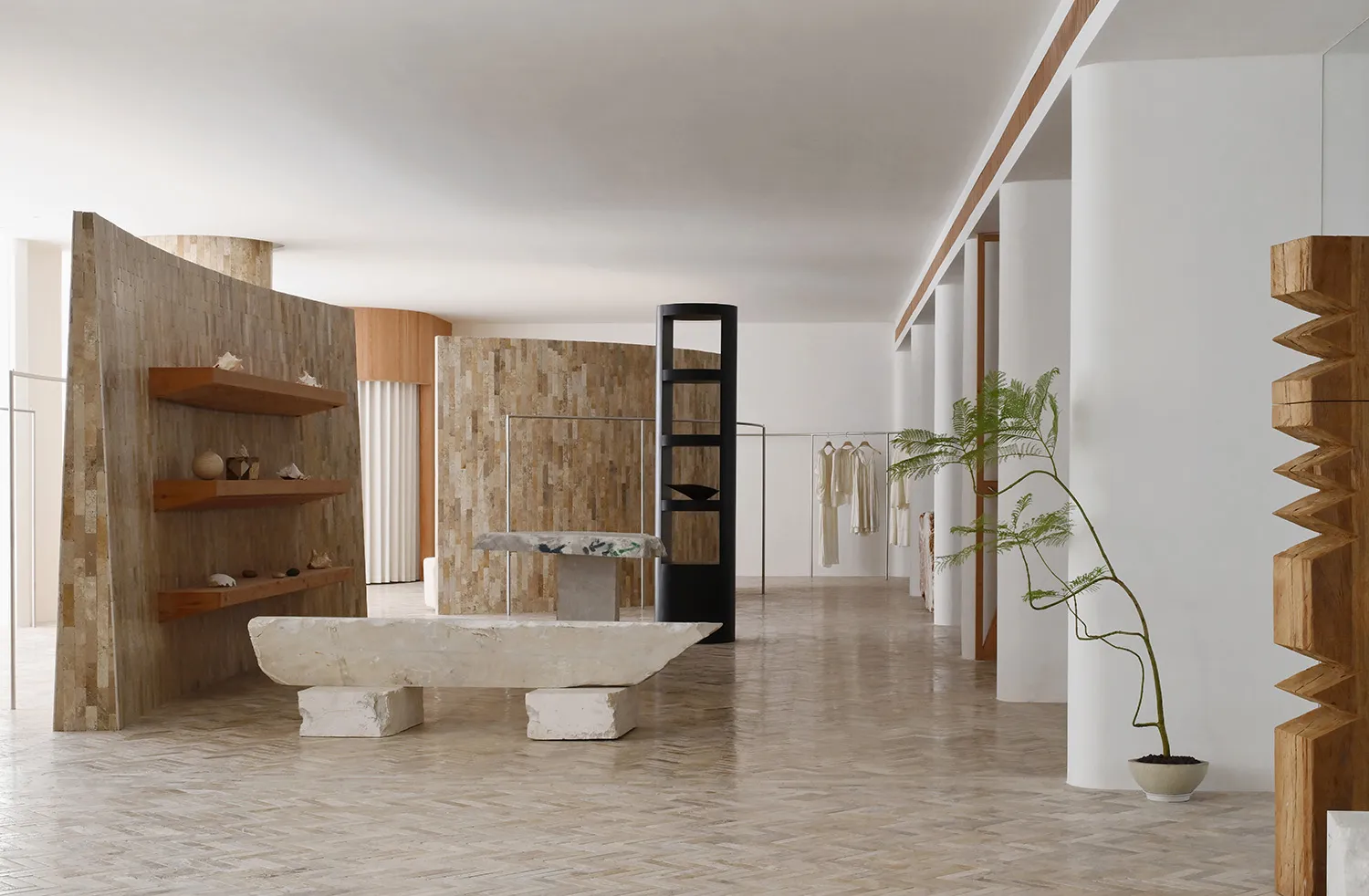 Minimalist retail store with concrete, wooden, and stone elements.